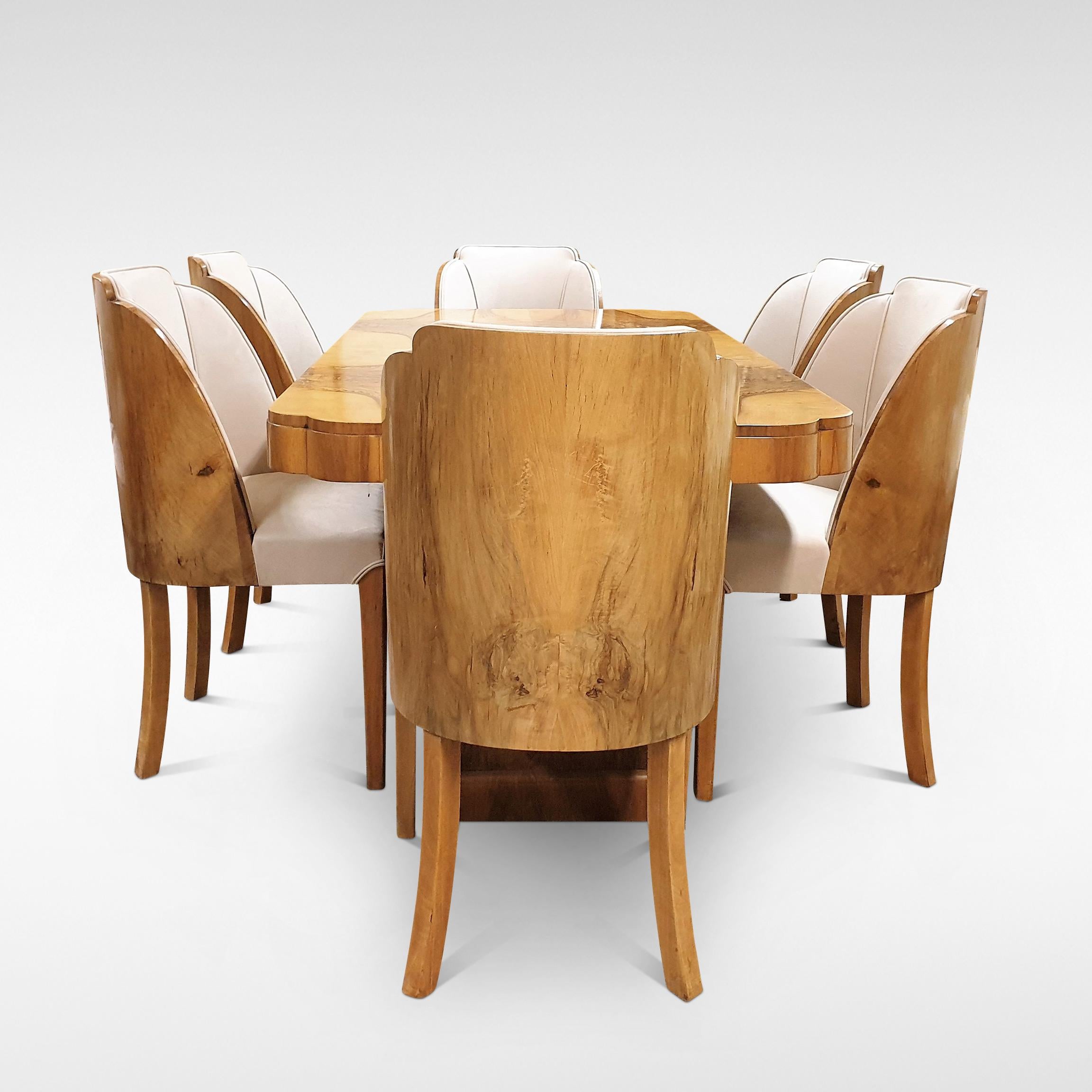 The work of the Epstein family represented a pinnacle of style and quality in English Art Deco furniture. Here we can offer a Dining Suite comprising a 6 seater Table in stunning figured Walnut veneers so characteristic of the Art Deco period,