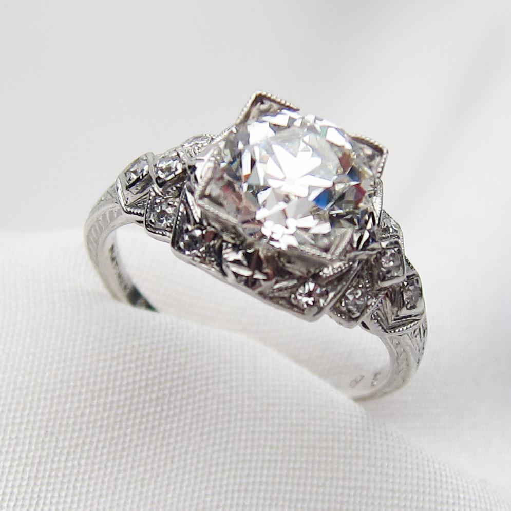 This absolutely divine Art Deco platinum ring features a dazzling central old European-cut diamond, weighing 1.86 carats with a VS1 clarity and I color. Each stair-stepped shoulder of the ring is bead-set with six single-cut diamonds (12 total),