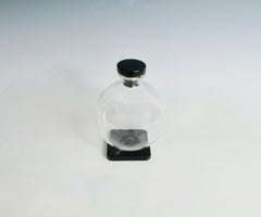 Art Deco era clear glass ball decanter with Onyx glass base and stopper