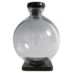 Art Deco era clear glass ball decanter with Onyx glass base and stopper