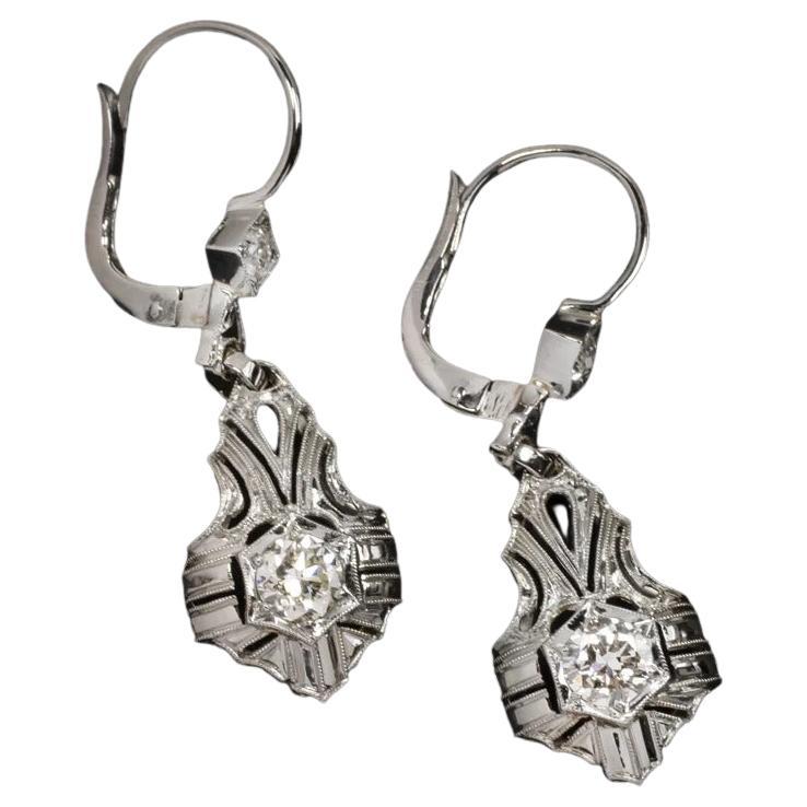 These diamond drop earrings are a gorgeous example of Art Deco era design and craftsmanship! They feature a vibrant 0.70ct pair of old European cut diamonds in stunning, hand detailed 18k white gold!

Highlights:

- Art Deco era vintage, circa