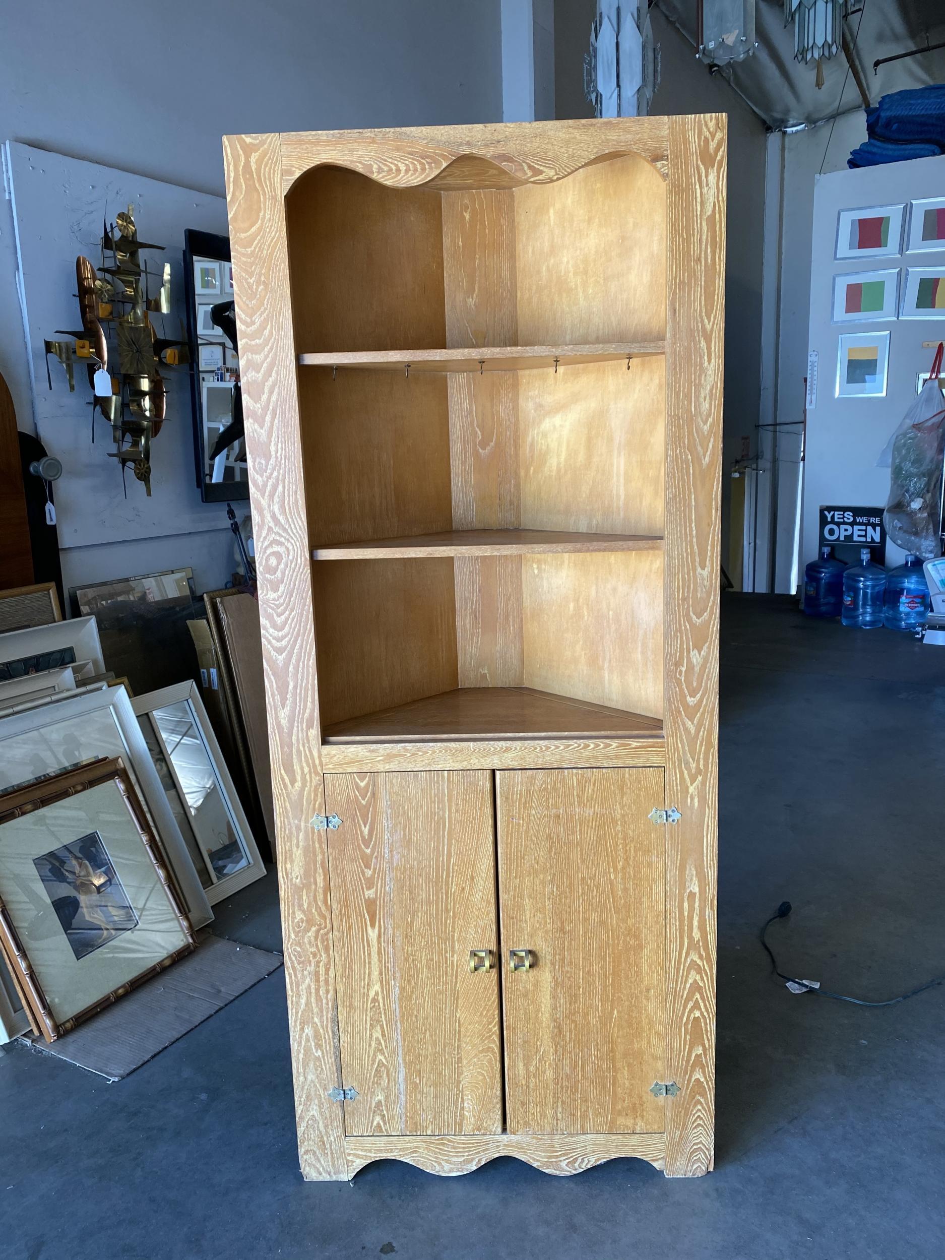 Art Deco era oak corner cupboard cabinet with 3 fixed shelves and double door cabinet underneath. 
The measurement of length of the sides to the endpoint is 18.5 inches, top center to the corner, 13.25 inches.  