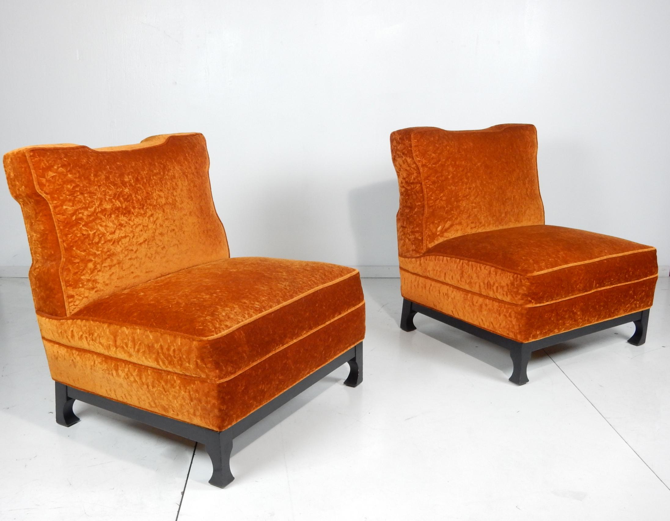 In the style of James Mont, these Art Deco era slipper/lounge chairs
are upholstered in soft orange crushed velvet with black lacquered base.
Both are in excellent clean condition. Solid with no frame damage or repairs.
Very comfortable.