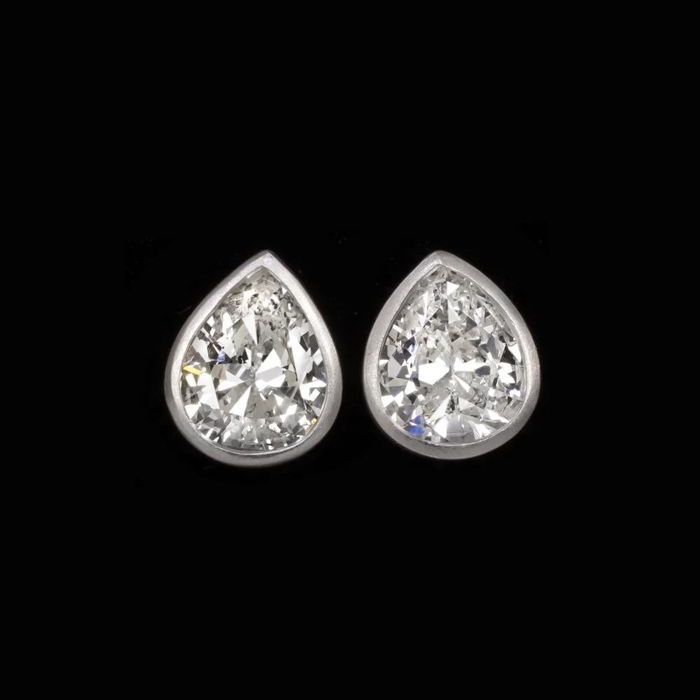  vintage pear shape diamonds! Vintage pear shapes are very hard to find, and this is a particularly beautiful pair with charming, broad bases.

Highlights:

- Substantial in size at just a touch under 2 carats total weight

- Bright white and eye