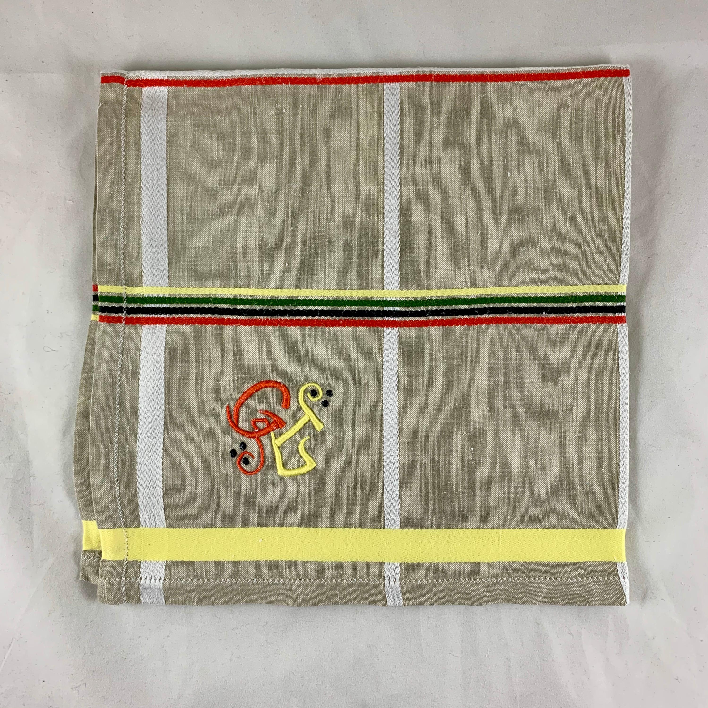 A set of twelve French Provençal linen serviettes with a bold embroidered monogram, circa mid-late 1920s.

The French linen napkins have a plaid design dating from the Art Deco era. Each serviette has a monogram with the initials G L embroidered