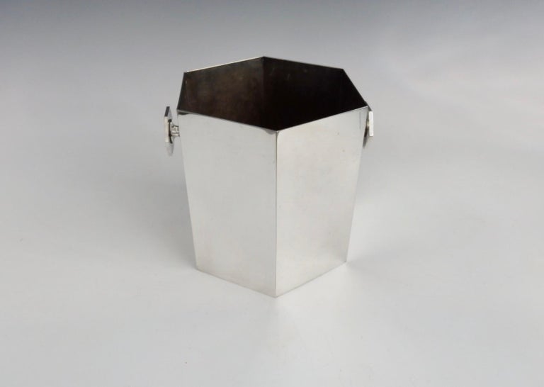 Machine age moderne ice bucket in geometric hexagon form. Matching hexagon lug handles on either side. I cannot decipher the hallmarks on the underside possibly French.