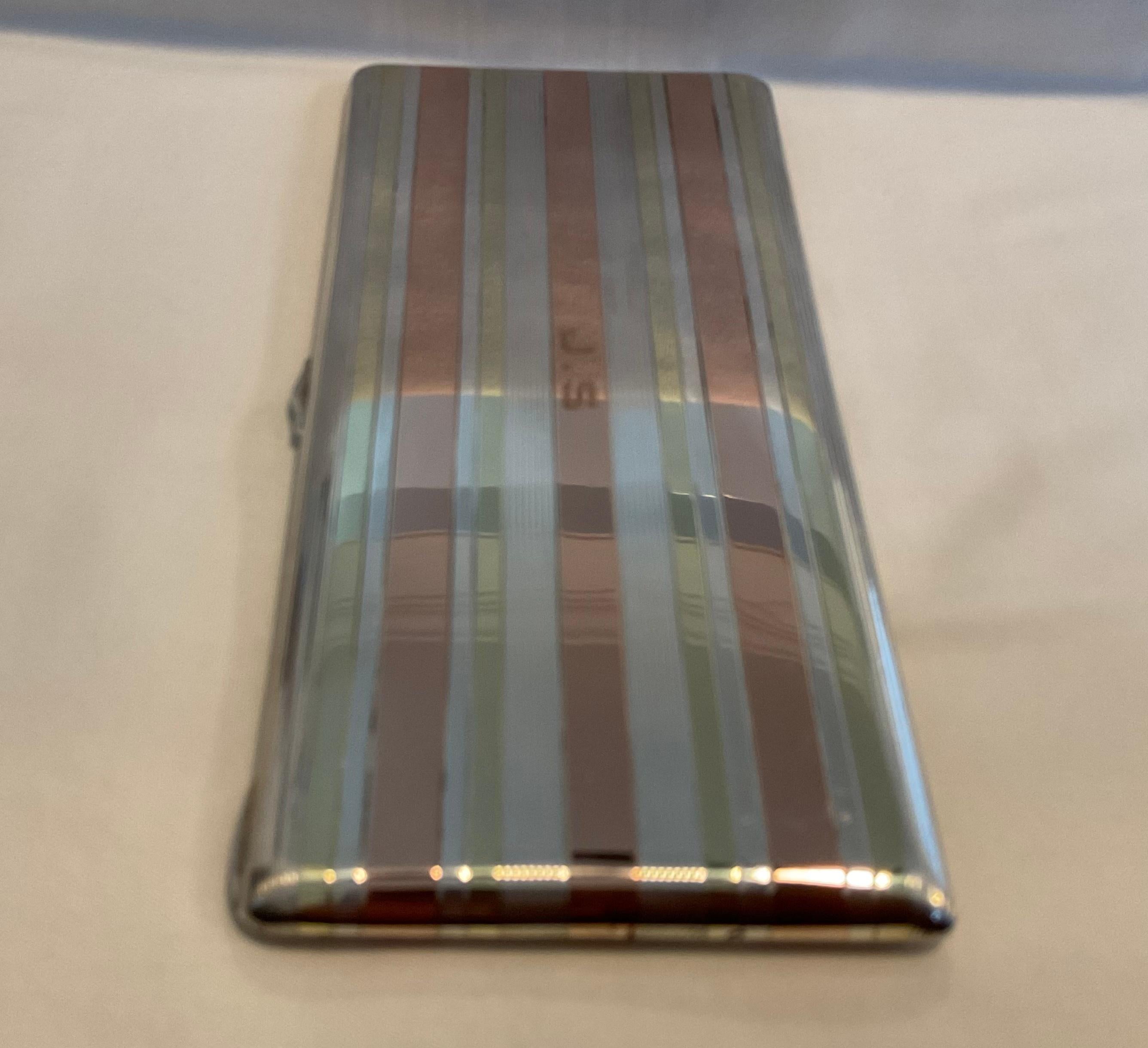 This cigarette case was crafted of solid sterling silver with rose gold lining on the exterior and 14K on the interior. The clasp and strong spring function as new and the case was made in the style of Cartier. It speaks of sophistication and style