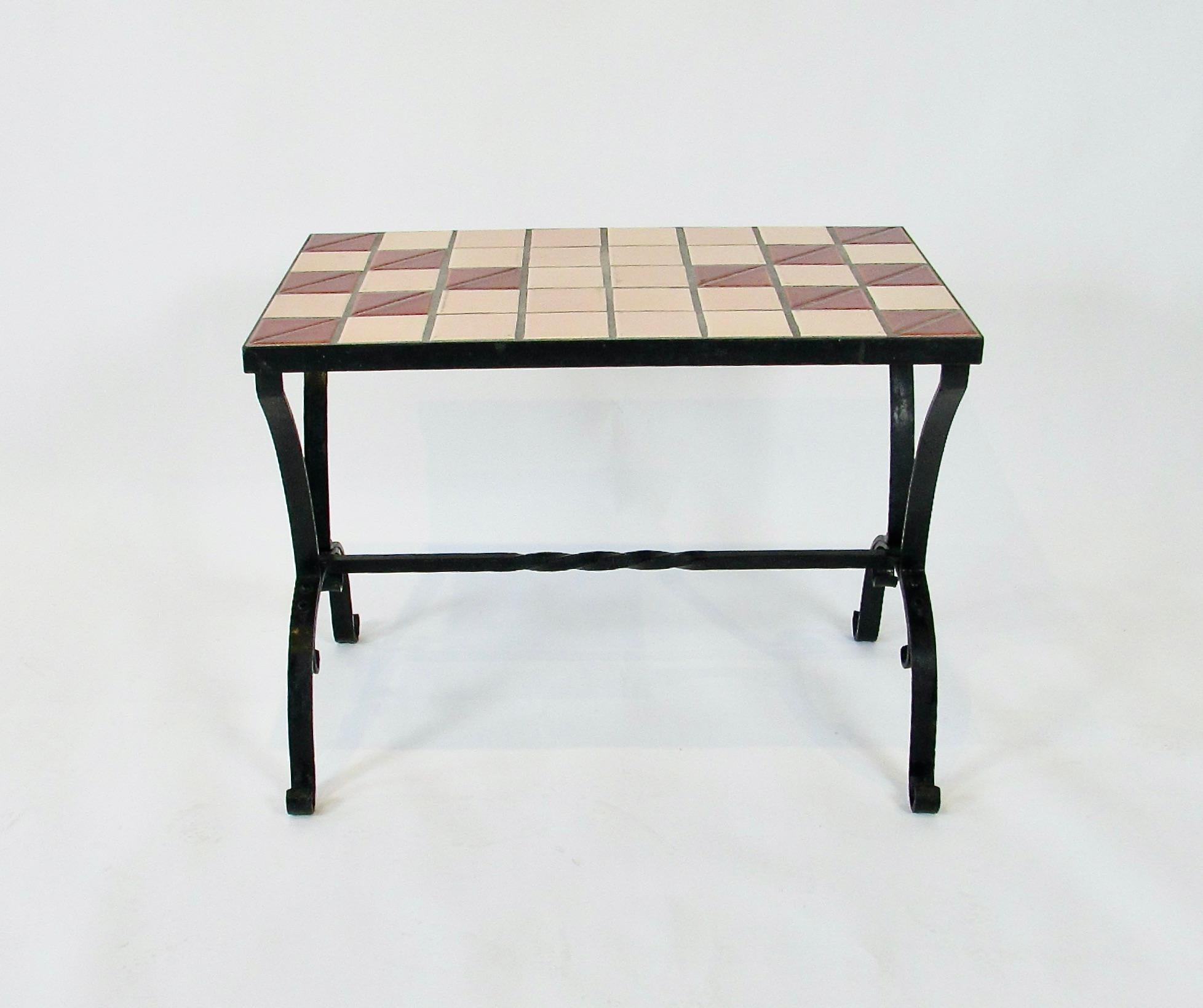 Art deco geometric patterned tile top mounted on wrought iron base . Early base with hot riveted joints . Tiles show mild wear but exceptional condition considering age .  