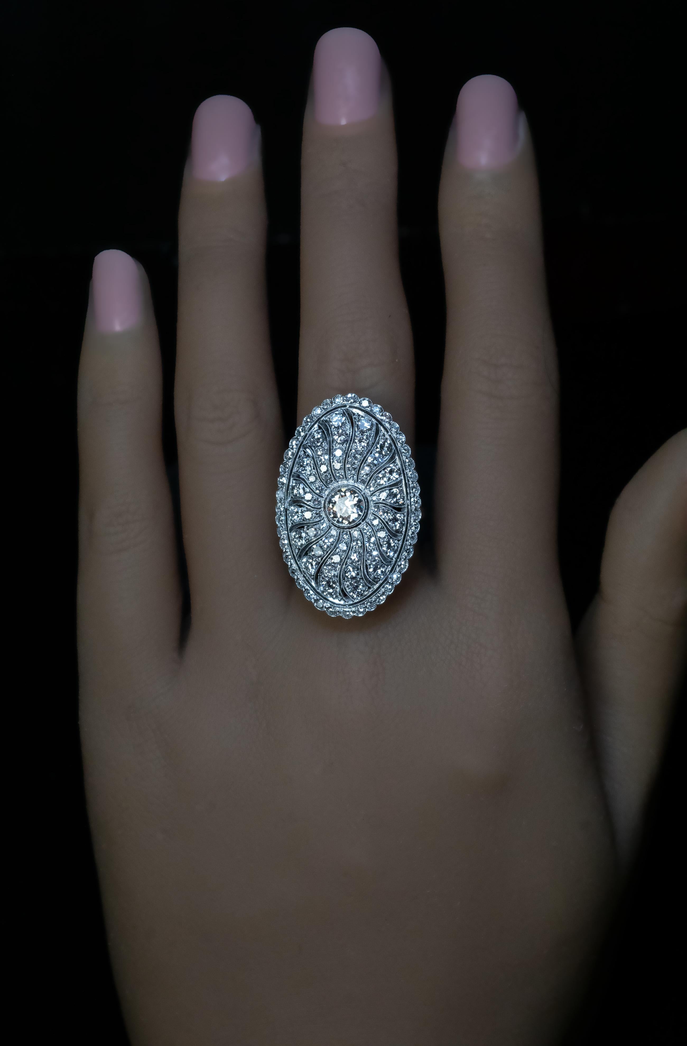 1920s
This openwork sunburst motif ring from the Art Deco era is superbly handcrafted in platinum (front) and 14K white gold (back). The ring is centered with an Old European cut diamond (J color, SI1 clarity, approximately 0.60 ct). The platinum