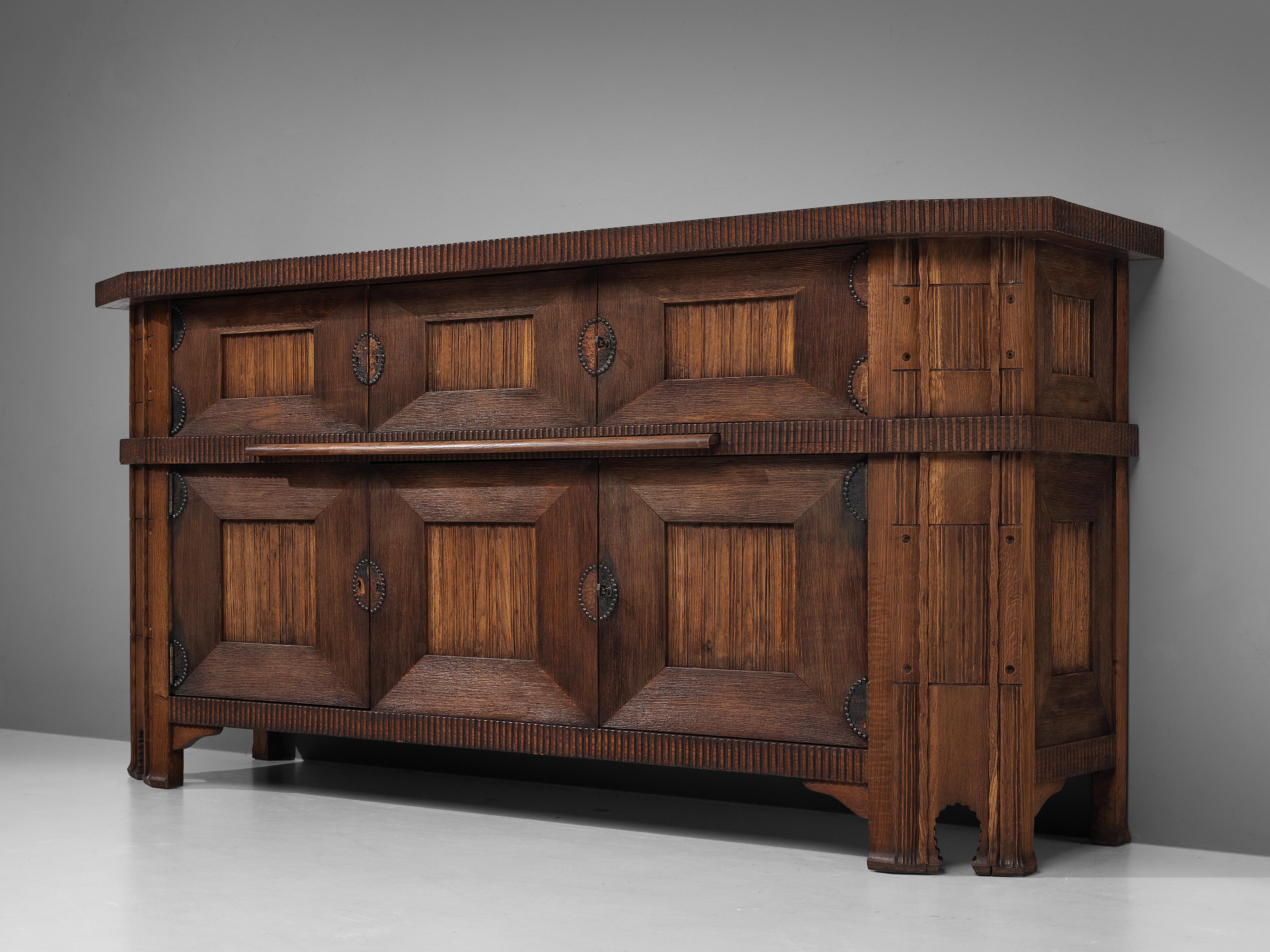 Ernesto Valabrega, sideboard, oak, Italy, 1930s.

This large Art Deco sideboard in oak by Ernesto Valabrega features not only visual qualities but also great storage space. Six doors are structuring the outside and are furnished with separate
