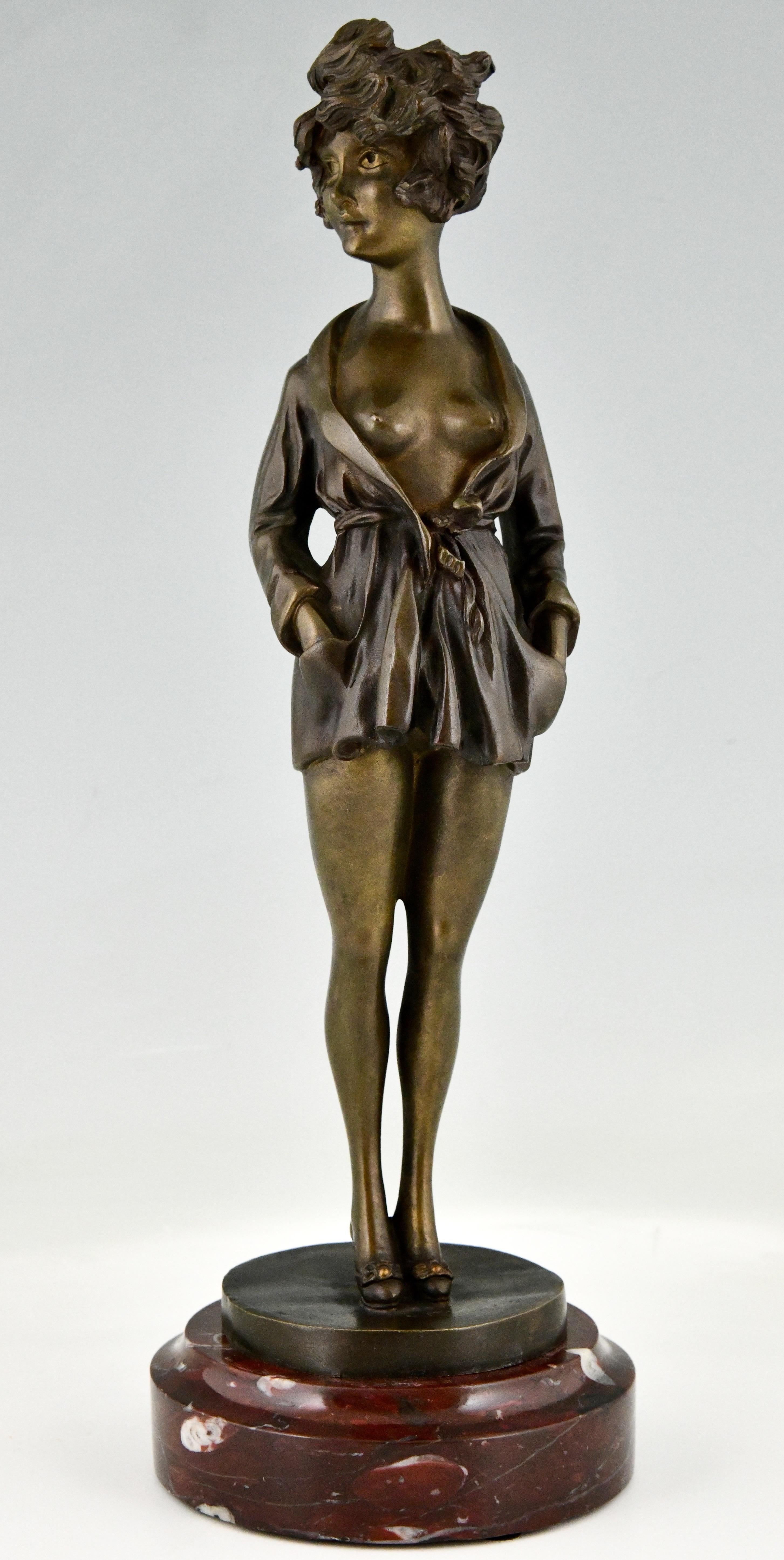 Art Deco erotic bronze nude in dressing gown, La Parisienne by Maurice Milliere on a red marble base
France 1930. 

Maurice Millière
French painter and illustrator 1871-1946.

Dictionnaire des peintres, sculpteurs, dessinateurs et graveurs by E.