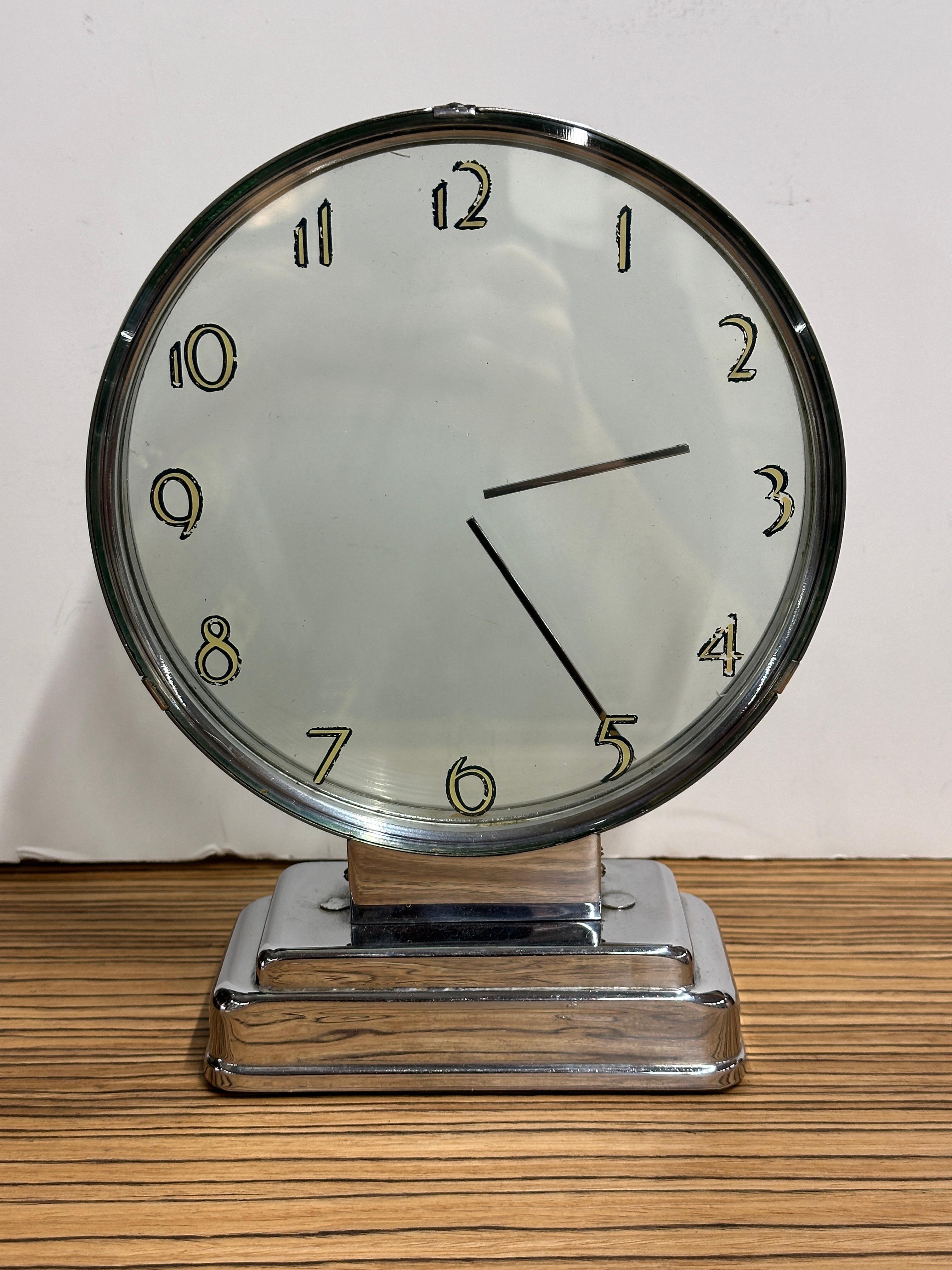 A stunning clock design by Etalage Reclame. The clock dates to the early 1940’s or late 1930’s. It is mystery clock. It has two disks inside with hands affixed to the plates that rotate. There is an outside disc on front with the numbers stenciled