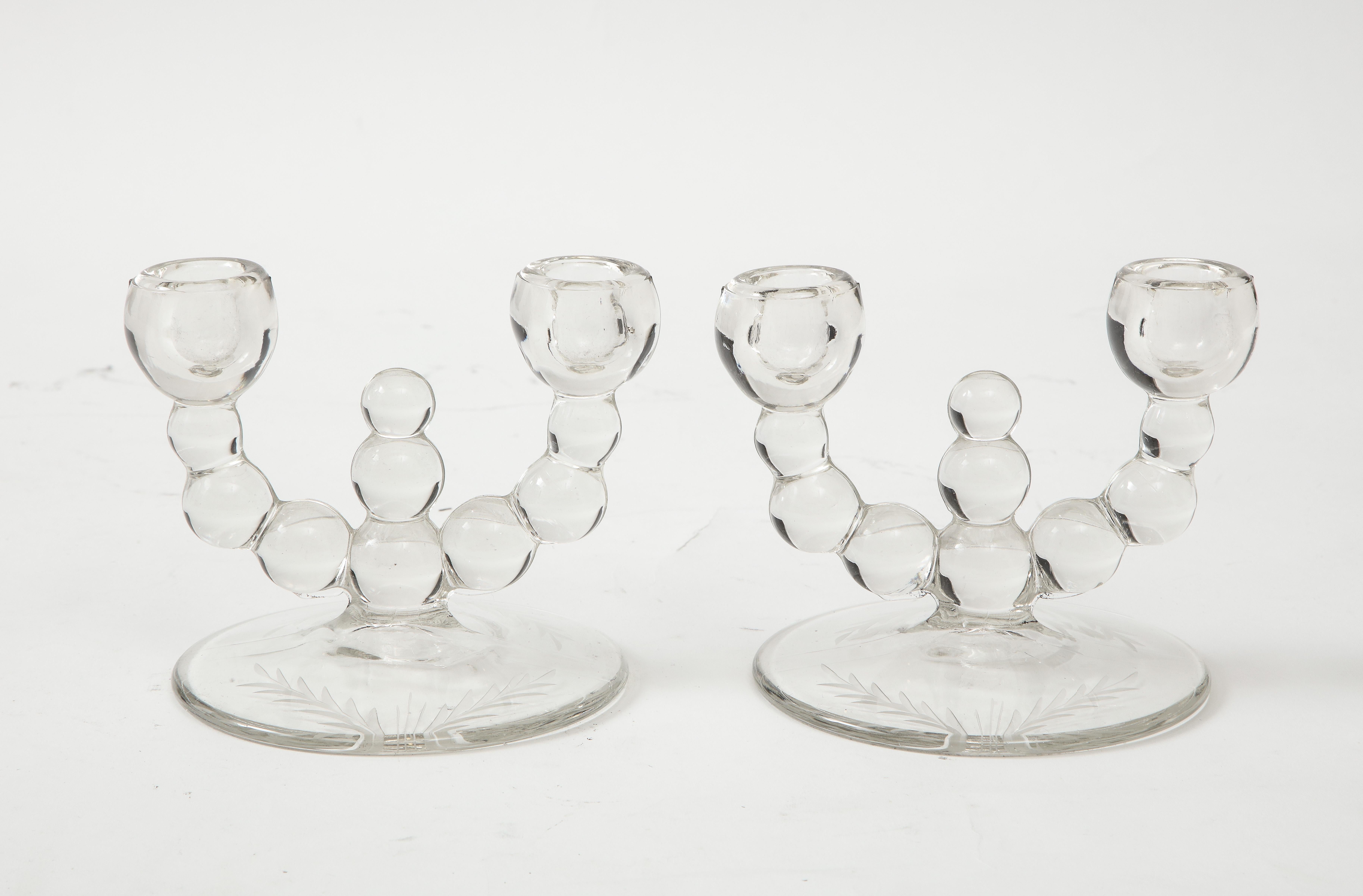 Pair of Art Deco glass candlesticks with segmented dodies and wheel etched details. Each candlestick holds 2 candles.