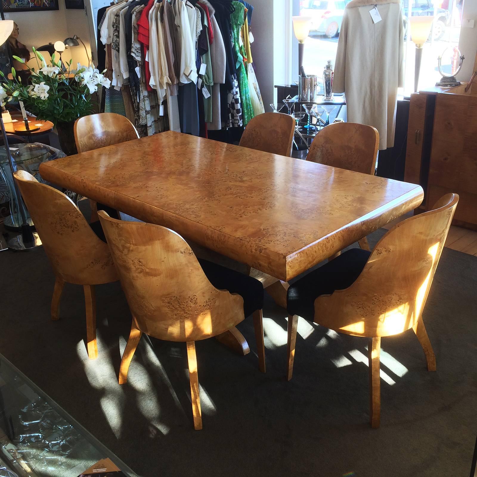 Art Deco spectacular European burl birch table and six chairs in amazing condition. Incredible reversed arch base with four feet extended below the arch. The work in this setting is phenomenal; the table has a convex side 11cm deep, fully veneered,