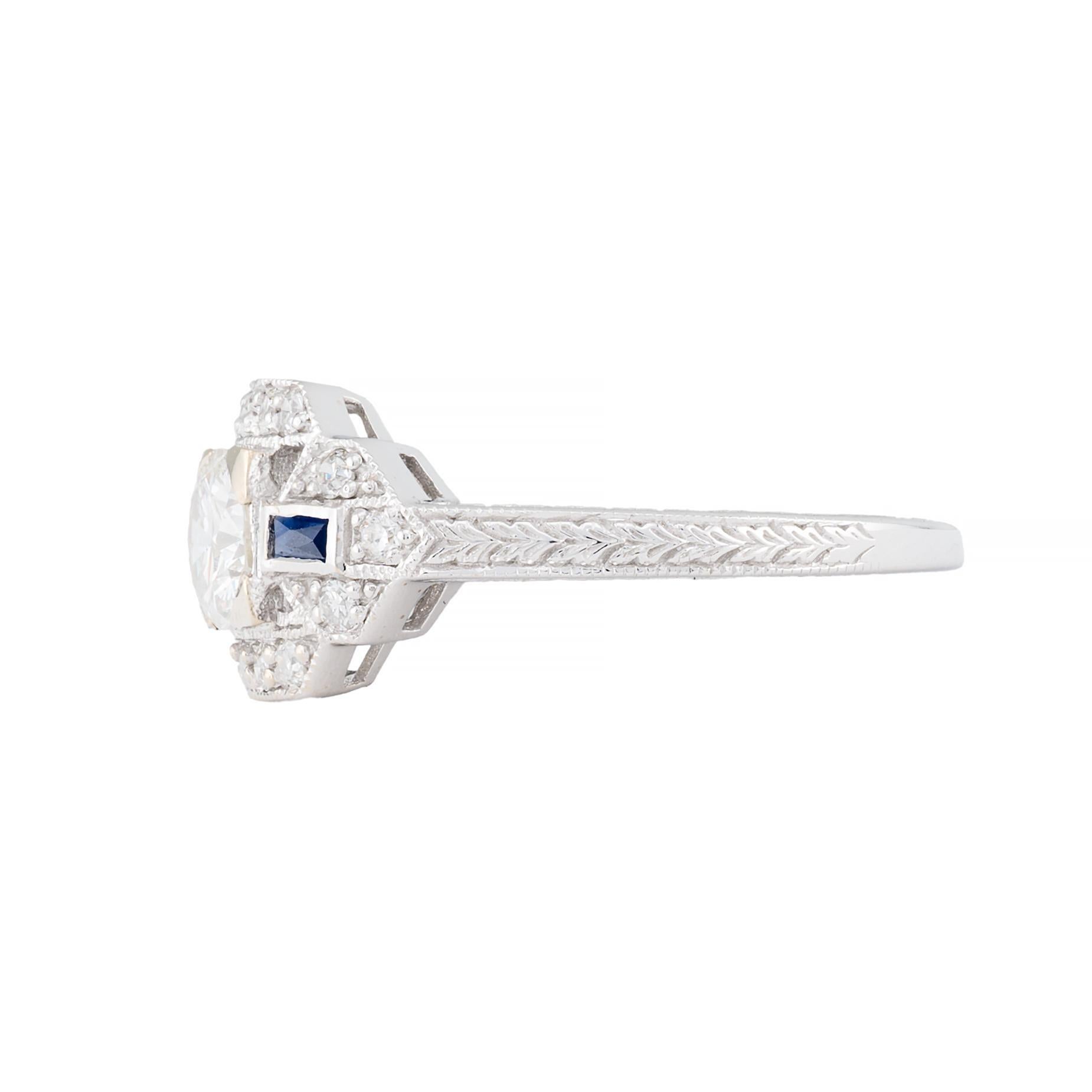 Aston Estate Jewelry Presents:

An elegant art deco engagement ring showcasing a central European cut diamond of 0.50 carats, H color, VS2 clarity. Flanked by baguette-cut blue sapphires totaling 0.12 carats. Additional pave set diamonds of 0.21ctw