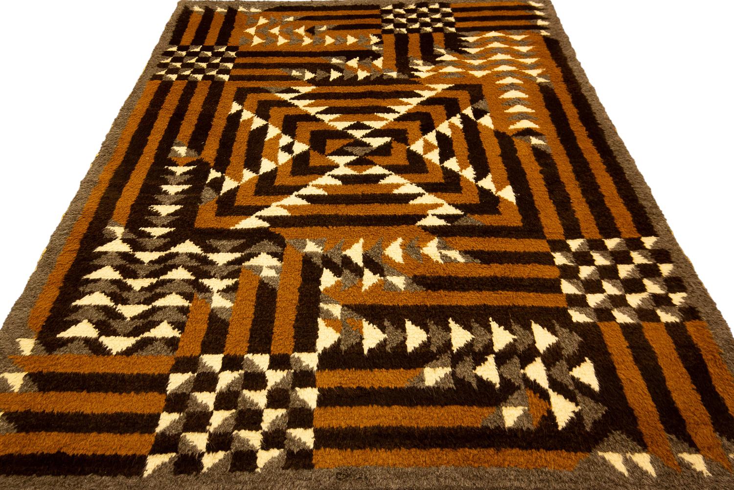 This is a semi-antique European Art Deco hand-knotted rug woven during the second quarter of the 20th century circa 1920 - 1950s and measures 230 x 170CM in size. This piece has a highly geometric design with squares creating a checkerboard and a