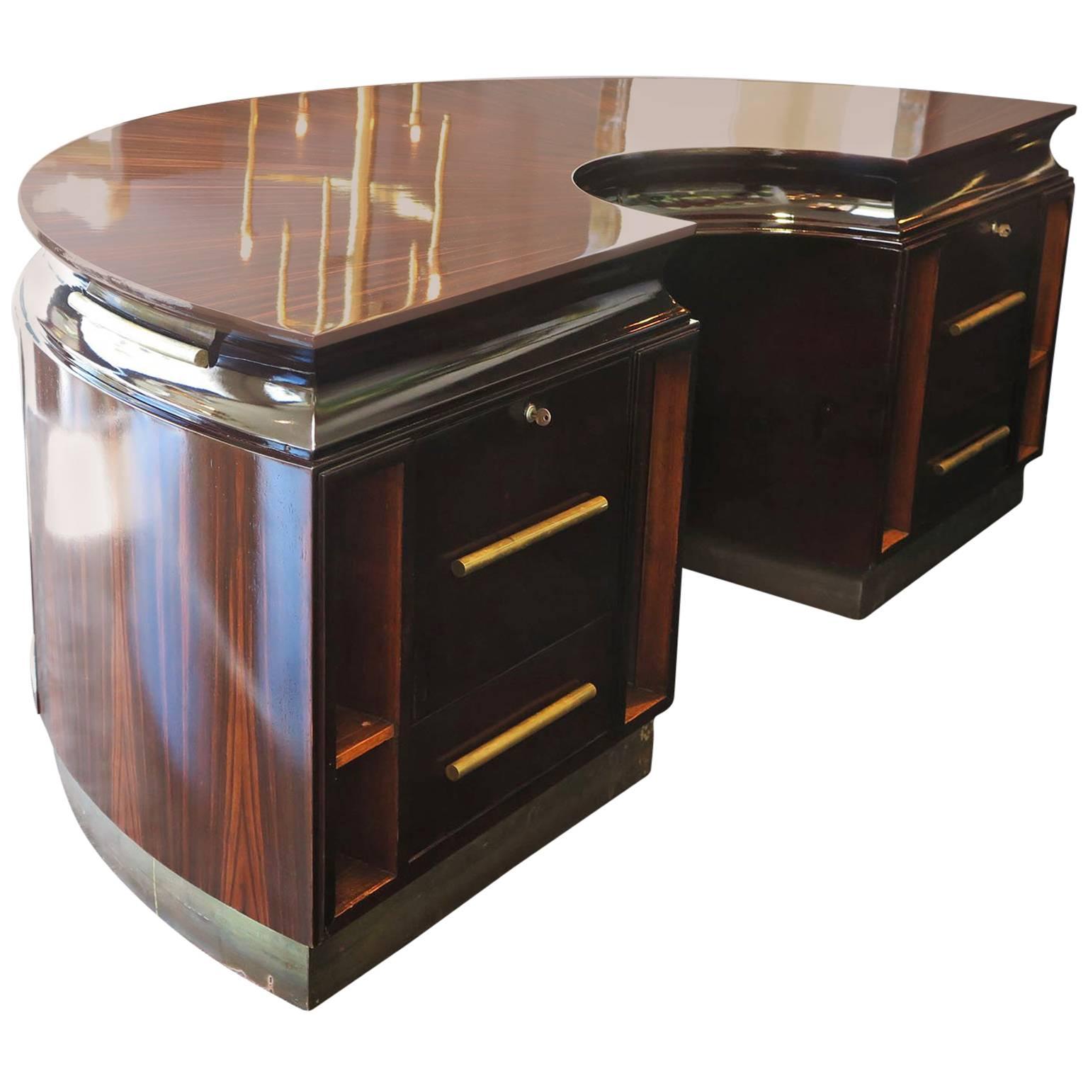 Grand demilune executive desk in Macassar ebony with a starburst design on top. Antique brass base and brass pulls add nice details to this desk. Five front brass pulls open to additional shelving.
Four mahogany niches in front offer space for
