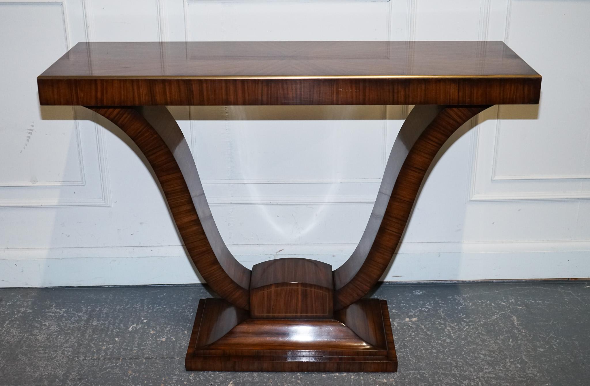 
Antiques of London



A striking Art Deco–inspired exotic Morado (rosewood) veneered console table, believed to be designed and crafted by Theodore Alexander. This statement piece showcases the brand’s renowned craftsmanship and attention to