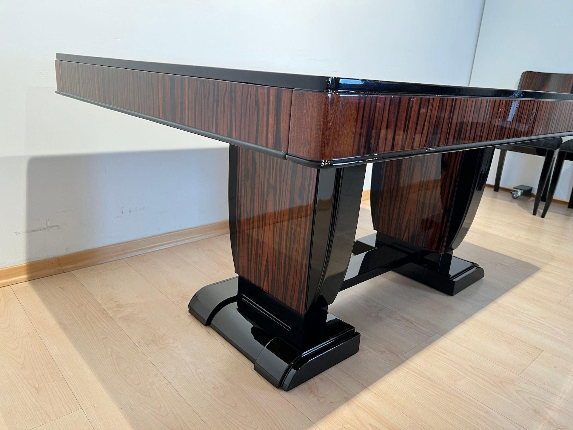 Atemberaubende Art-Deco-Esszimmergarnitur mit erweiterbarem Tisch und acht Stühlen aus Makassar-Furnier und schwarzem Lack.

Ausziehbarer Esstisch mit Platte und Schürze in hellem Makassar-Ebenholz furniert. Hochwertige