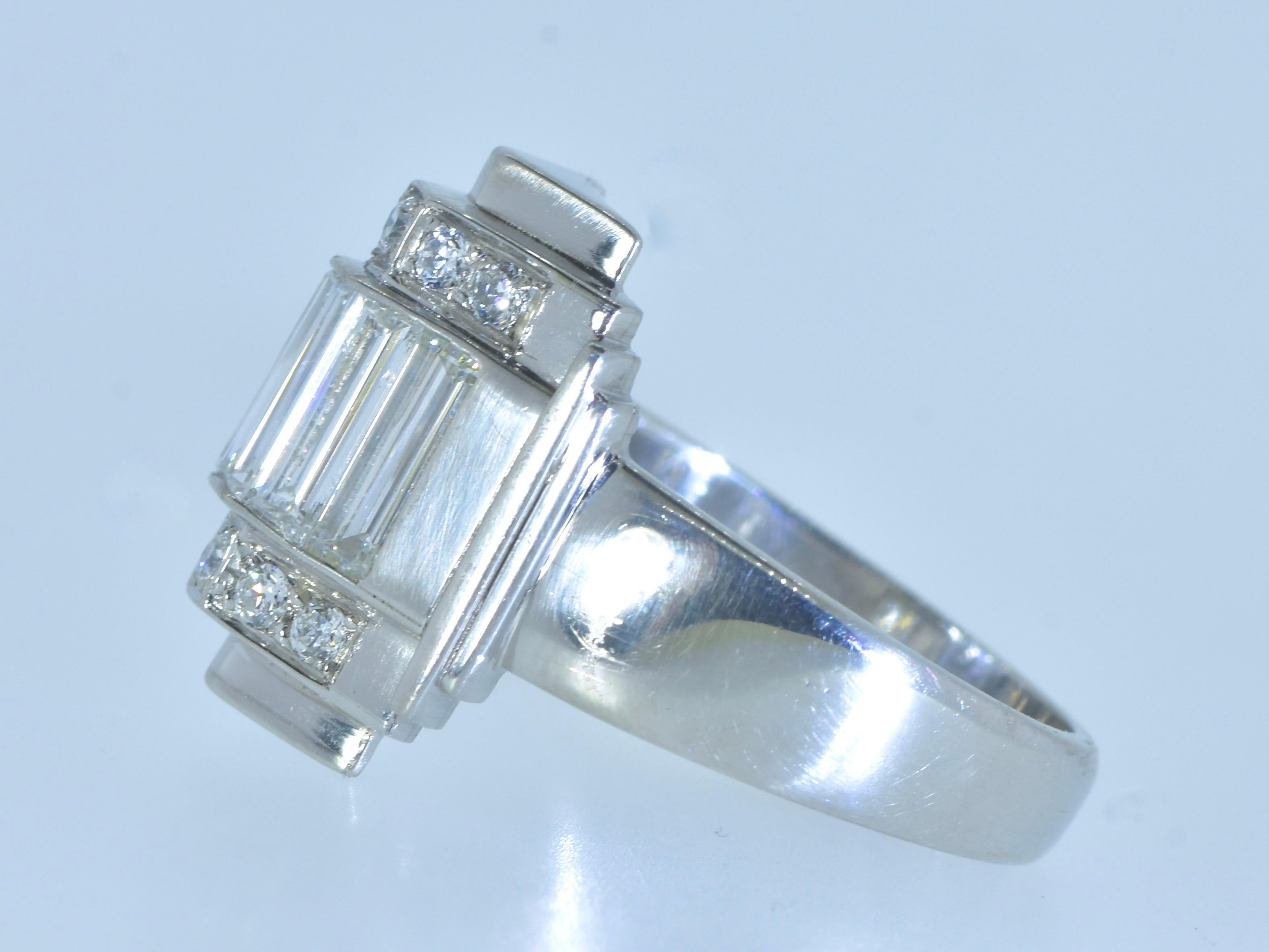 Art Deco Diamond Ring.  Long baguette cut white diamonds centers this geometric statement.  The diamonds are all white, near colorless (H) and very slightly included (VS).  The smaller diamonds accenting the major diamonds are also of the same fine