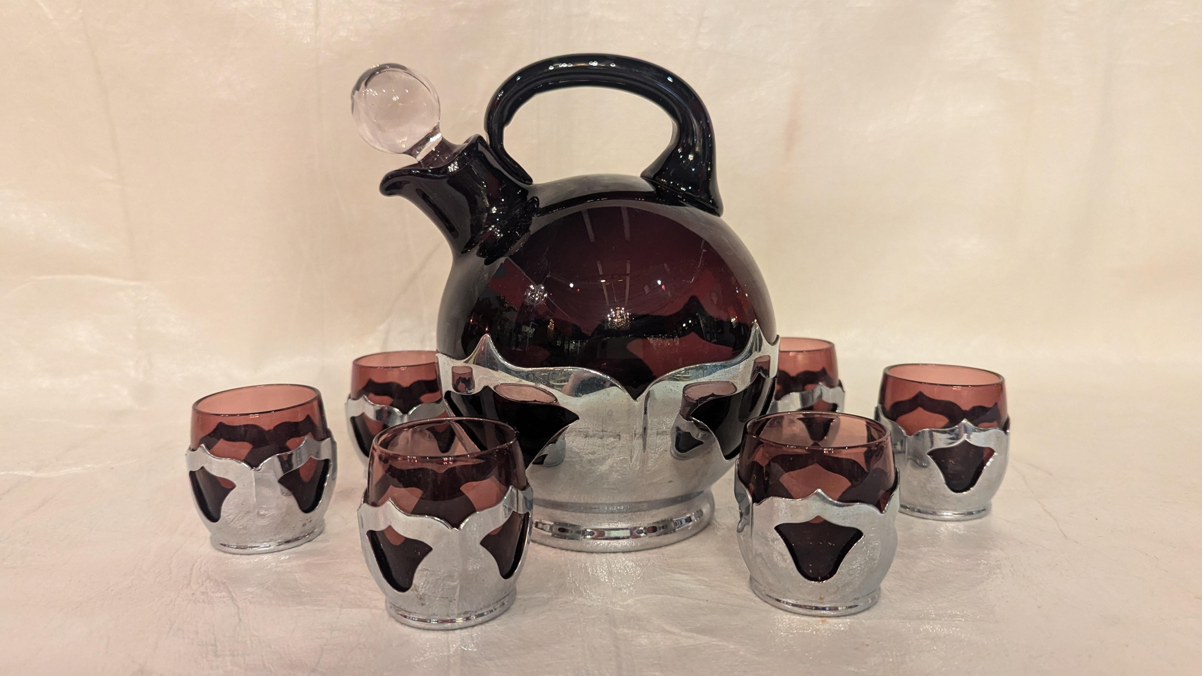 The height of Art Deco Farberware and Cambridge glass ball jug decanter with stopper and 6 shot cordials in aubergine purple and chrome.  Ball jug 5