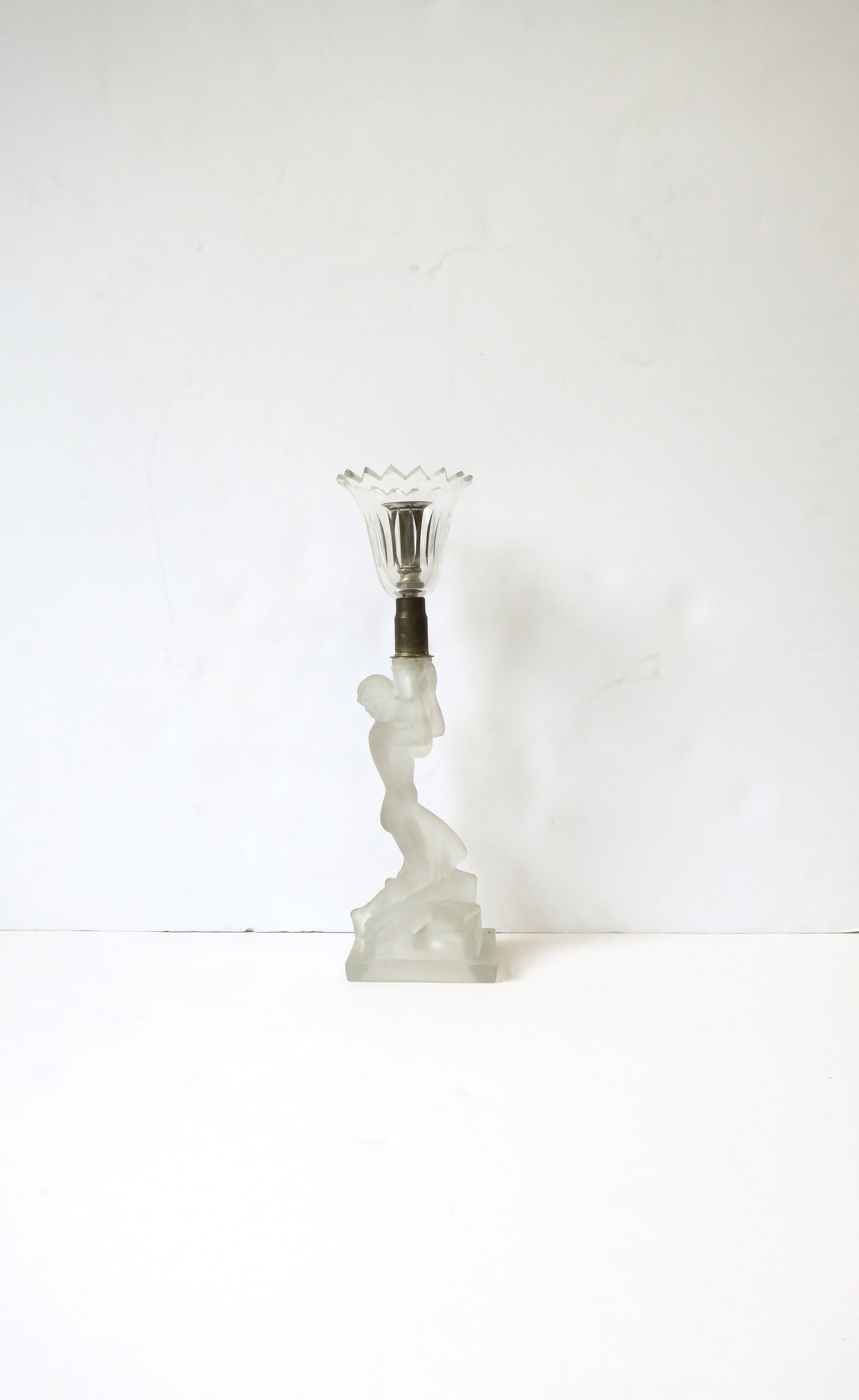 A beautiful Art Deco period female figurative candlestick holder attributed to French crystal Maison Lalique, circa early 20th century, Europe. An Art Deco period piece depicting a woman shown kneeling and holding troche. Beautiful as it's intended
