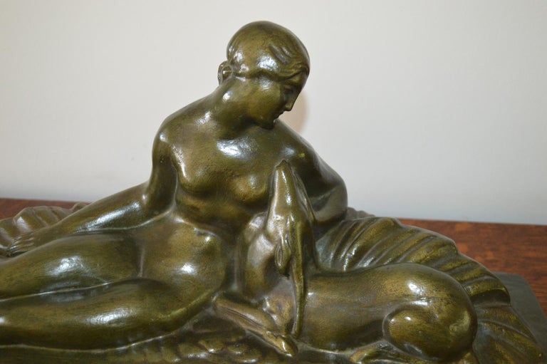 A beautiful original Art Deco figural group of a reclining lady with a deer. Handmade from terracotta with a bronzed finish in France and dating from circa 1920-1930. Signed on the rear by the artist 