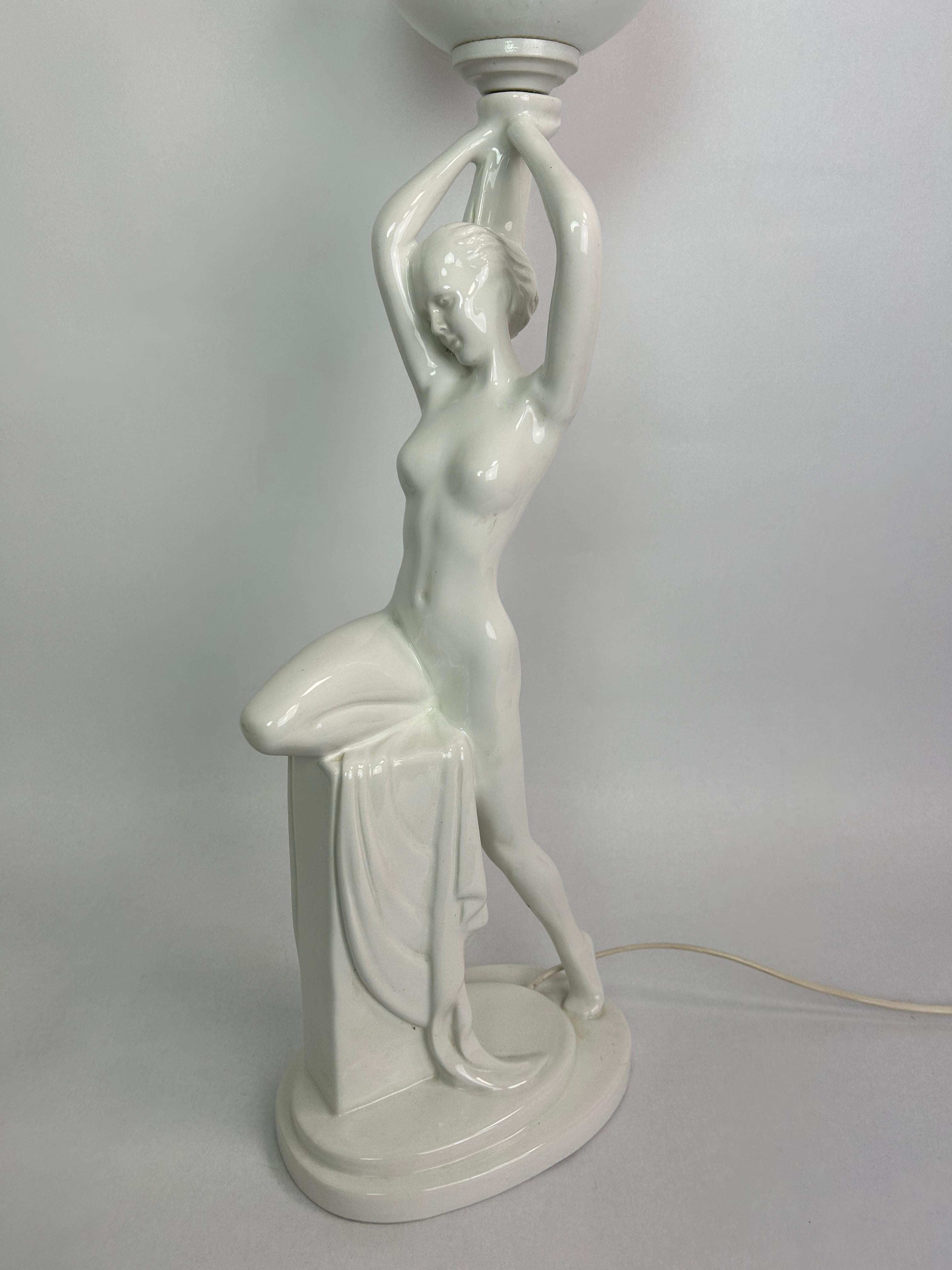 Art deco figural lamp standing nude with opaline glass lampshade.