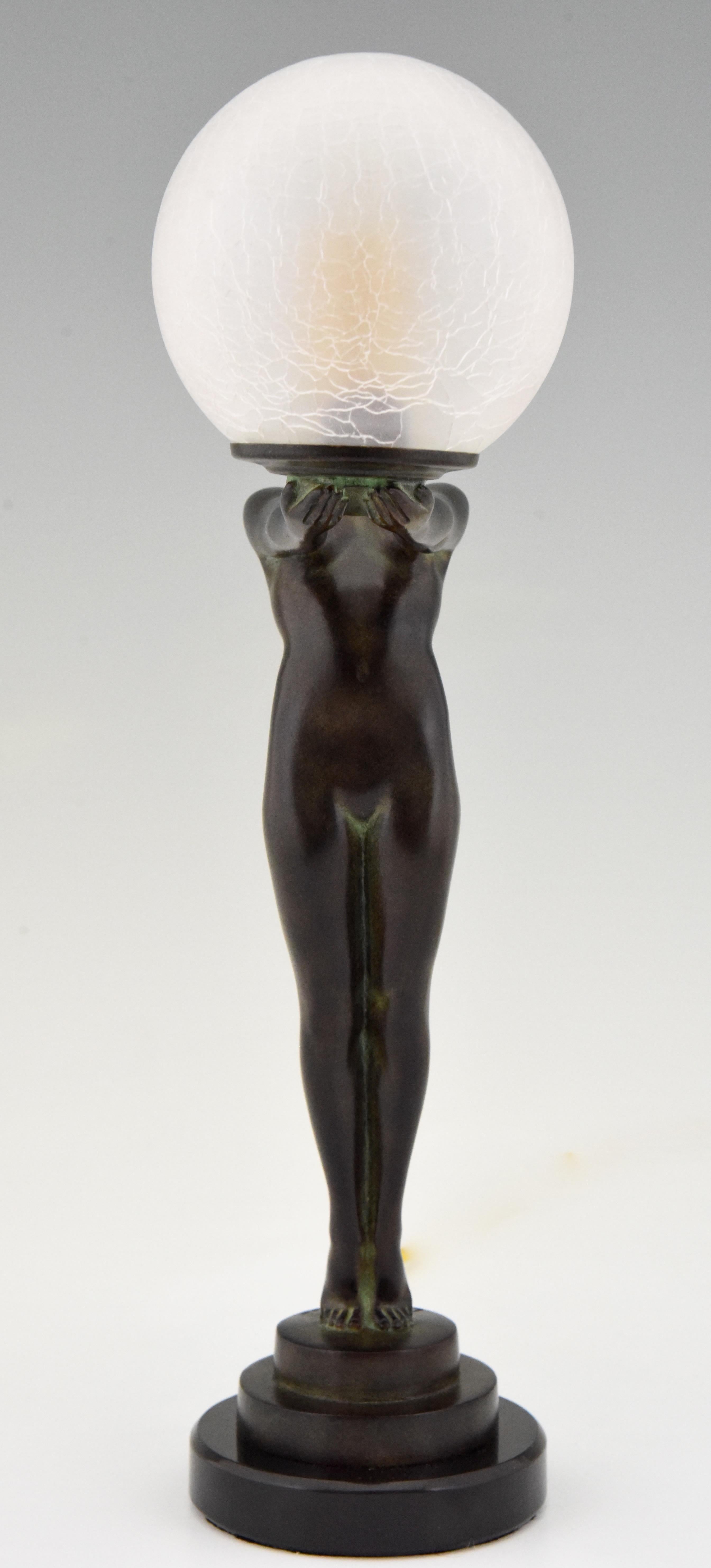 Patinated Art Deco style Lamp Standing Nude Holding a Glass Shade Max Le Verrier Clarté