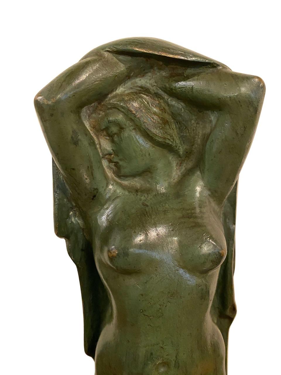 Figurative Art Deco sculpture of standing woman in bronze on marble. Important Belgian sculpture with great history and background. Unique piece in verdigris on bronze stylized Art Deco era circa 1930s. The woman is draped in a cape or shawl in a