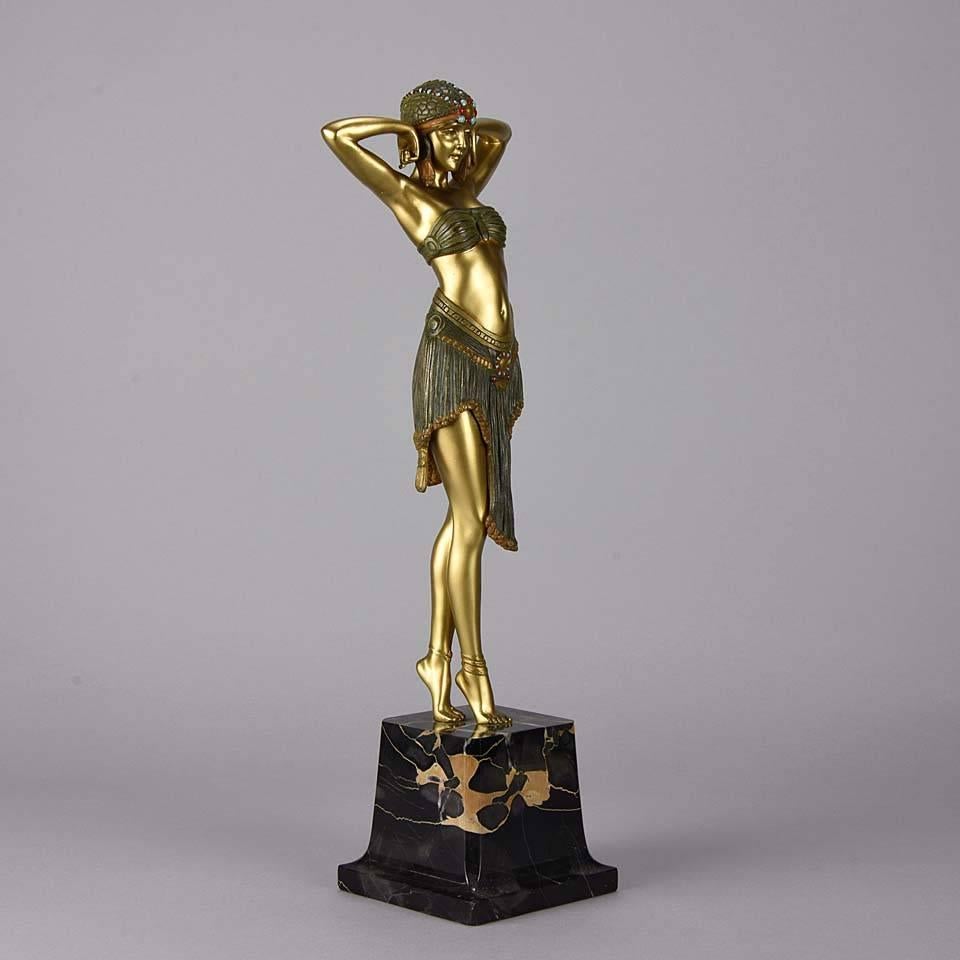 Marvellous cold painted Art Deco bronze figure of a beautiful Ballet Russes dancer wearing a two piece outfit and a stylish head dress, exhibiting excellent color and very fine hand finished detail. Raised on variegated shaped marble plinth and
