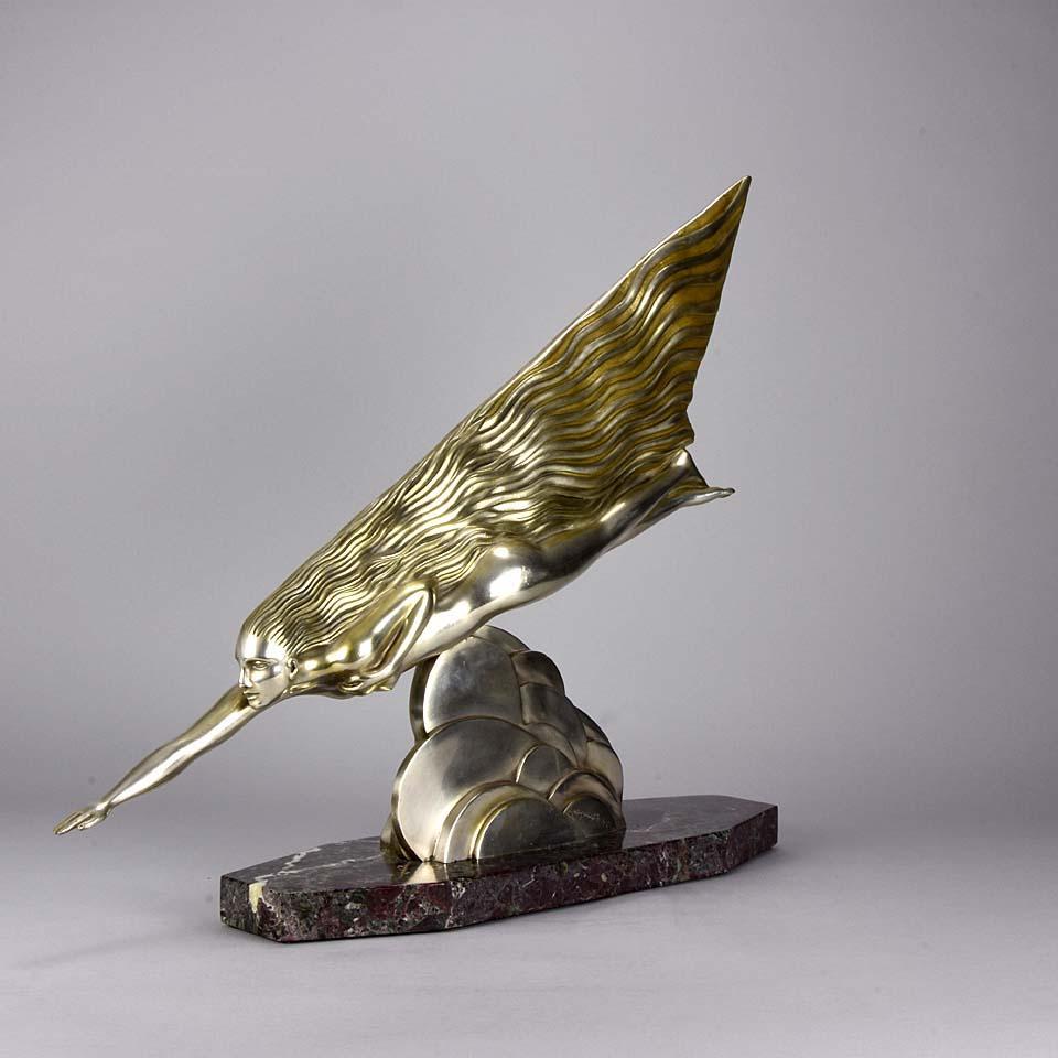 La Comète is a magnificent Art Deco sculptural image of a female nude modelled as a streamlined comet, her long hair trailing behind her as she flies through the clouds. The silvered bronze sculpture is heightened with parcel gilding and raised on a