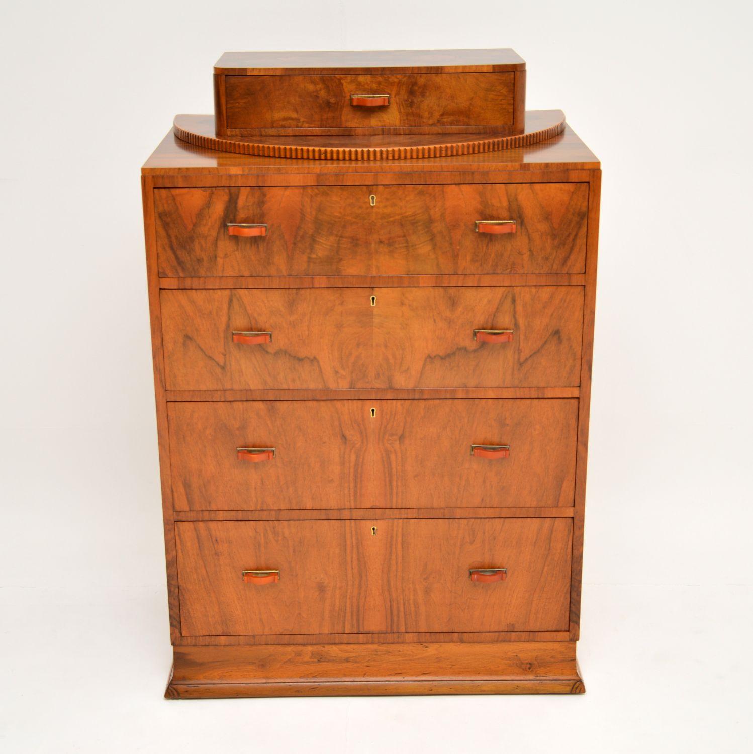 A gorgeous and unusual original Art Deco period chest of drawers. This is beautifully made from walnut, it dates from the 1920s-1930s.

The design is lovely, with a typical symmetrical Art Deco shape, and an interesting smaller upper drawer on the