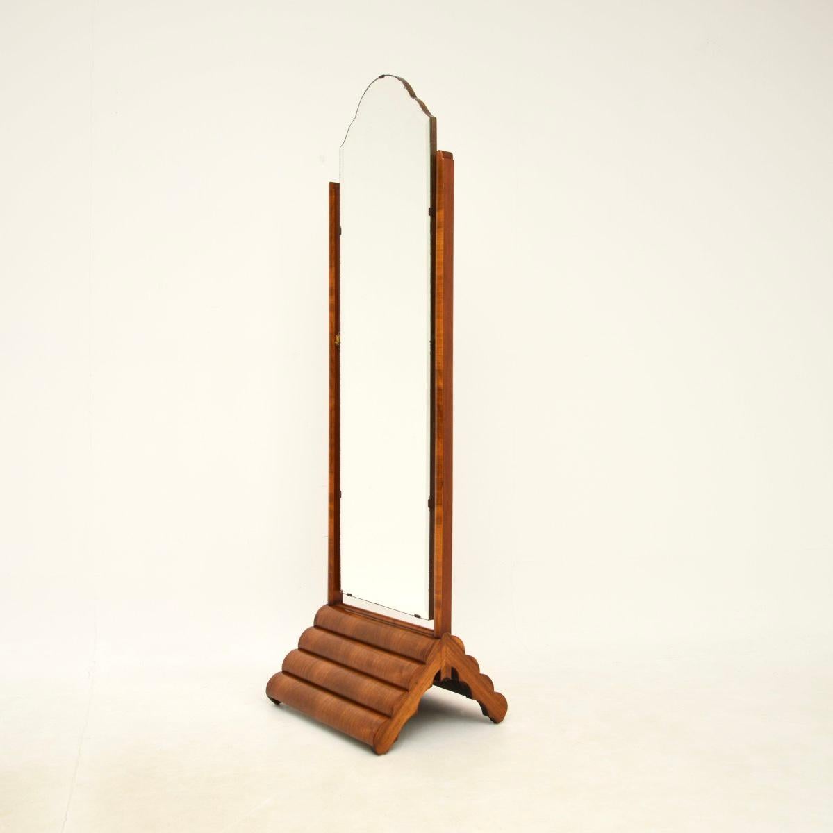 A superb original Art Deco figured walnut cheval floor mirror. This was made in England, it dates from the 1930’s.

It has a stylish and quite unusual design, the quality is outstanding. The base is arched with wonderful curved segmented sections,