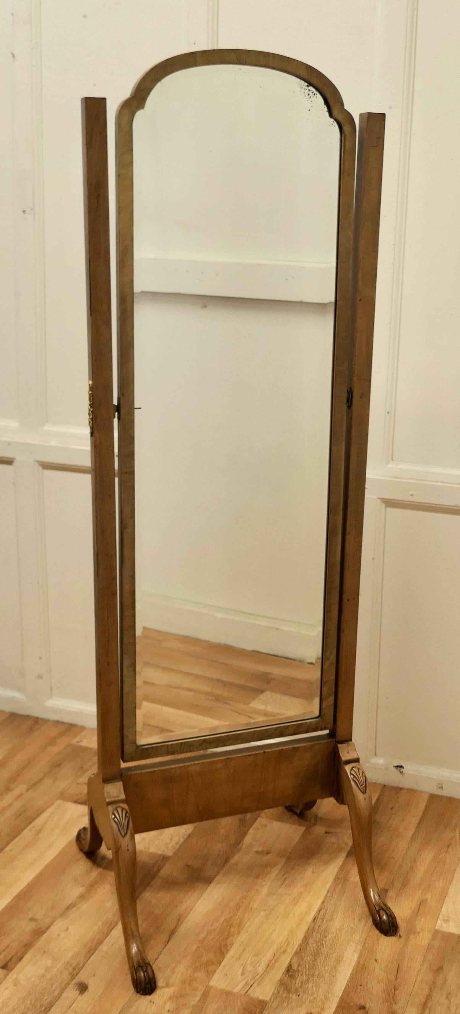 Art Deco Figured Walnut Cheval Mirror. 


The Mirror stands on a good sturdy frame which has carved cabriole legs and an arch top and it sits firmly in its stand and swivels for maximum advantage.
 Both the Stand and Mirror are in used but still