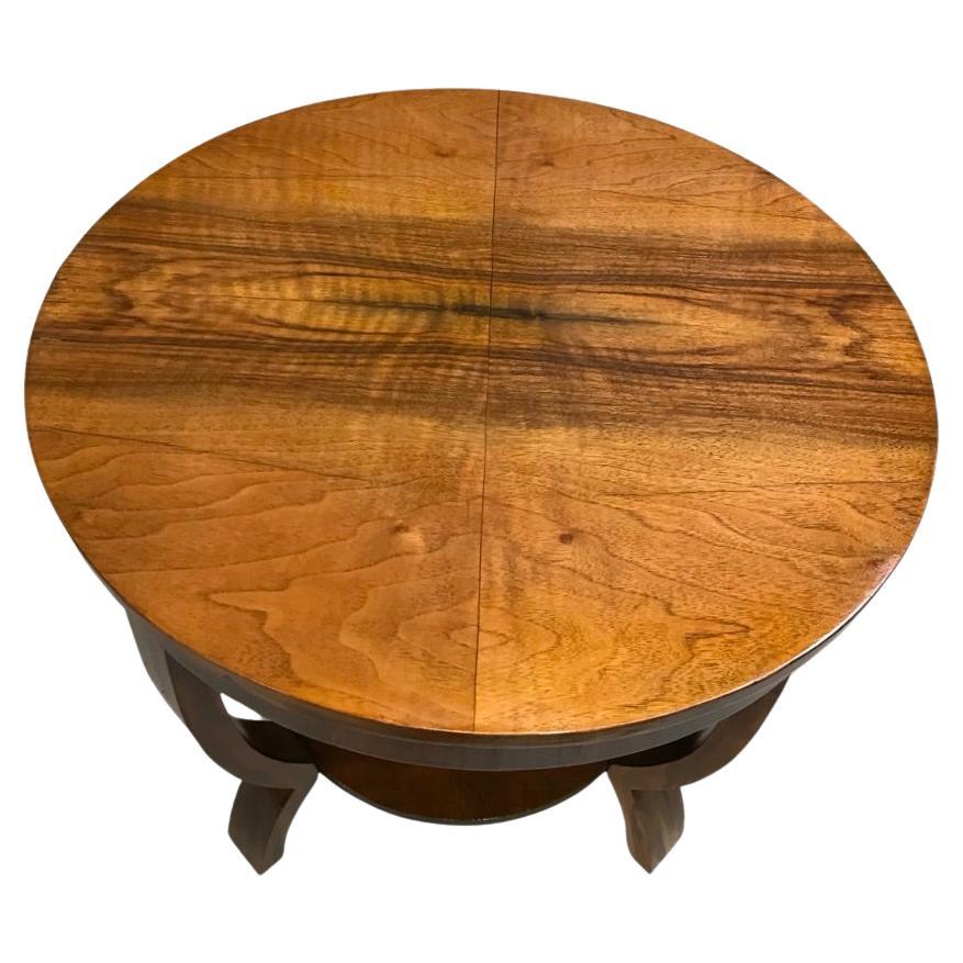 Circa 1930, a lovely circular figured walnut Art Deco coffee table. The top is book paged, figured walnut and again the legs are in figured walnut. Has a lower tier. It has been sympathetically restored to a gorgeous condition and is ready to grace