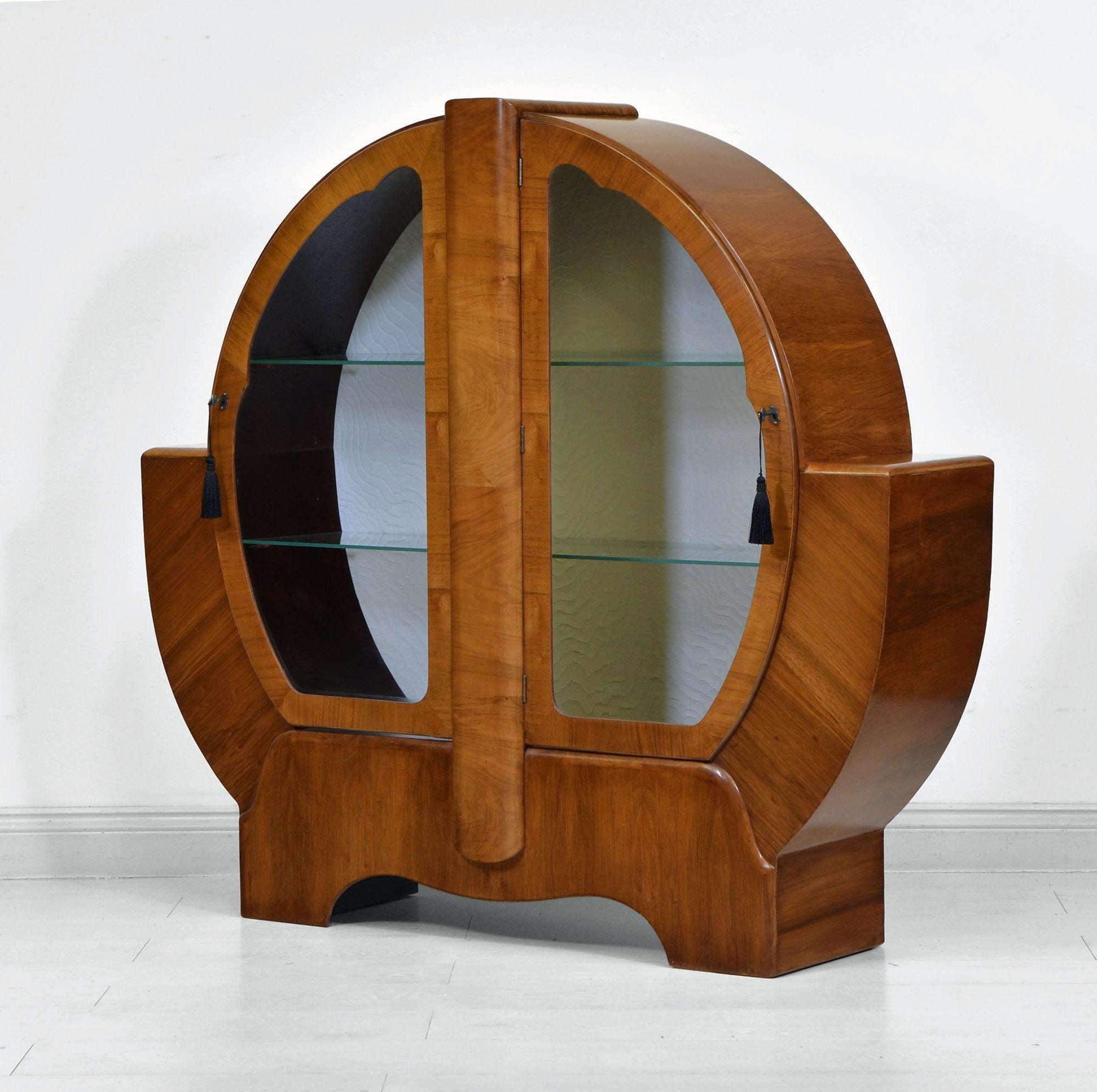 A stylish Art Deco figured walnut display cabinet. England Circa 1930's.

The cabinet has wonderful figured walnut veneers and has been re-finished by hand in a shellac sealer. It has a smooth waxed polished finish, retaining a few light authentic