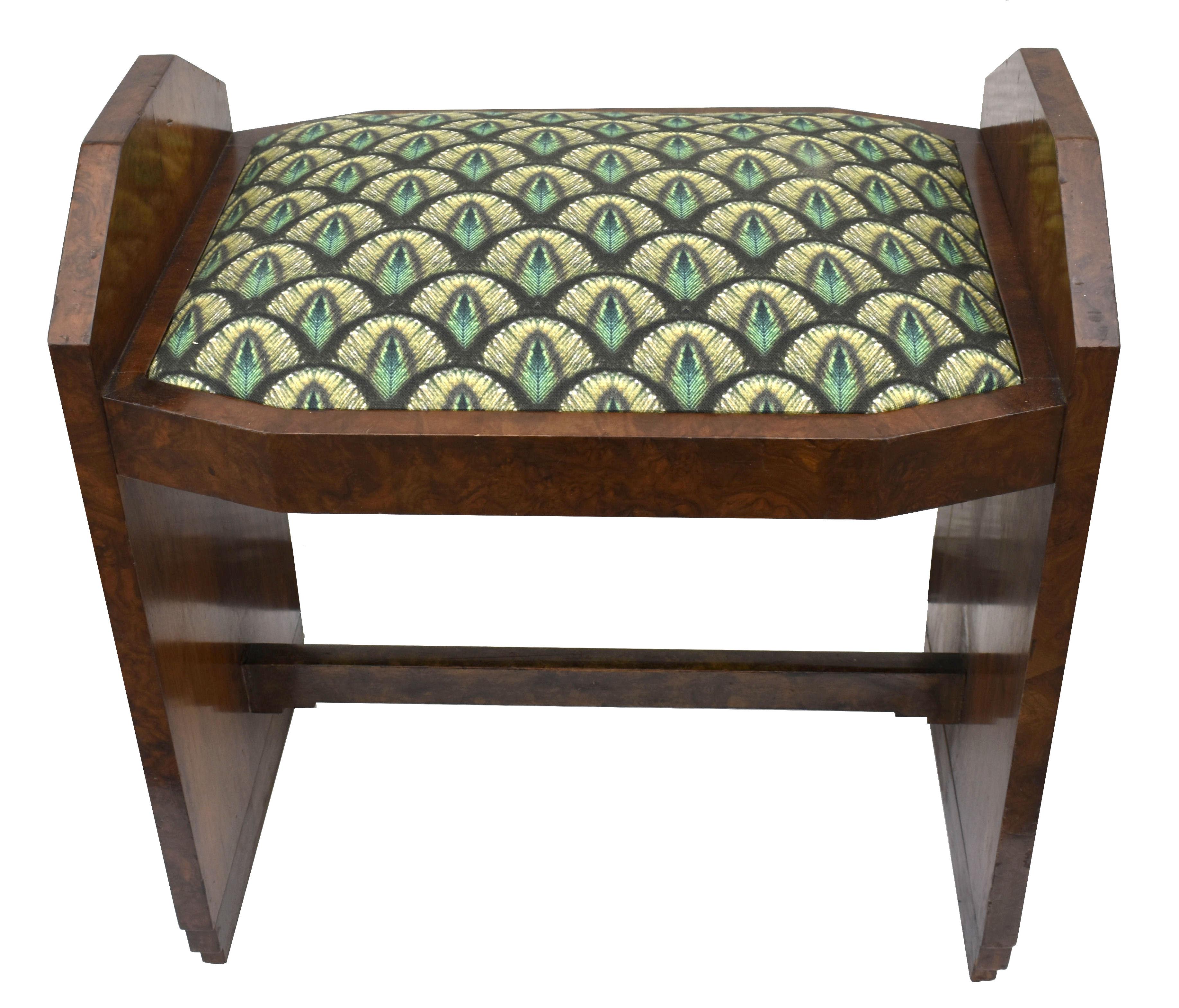 Very stylish Art Deco dressing stool dating to the 1930s, can be used for dressing table or footstool. Newly reupholstered in an Art Deco style fabric, beautifully figured walnut veneers. Wonderful and iconic stepped shape to the sides. Offered to
