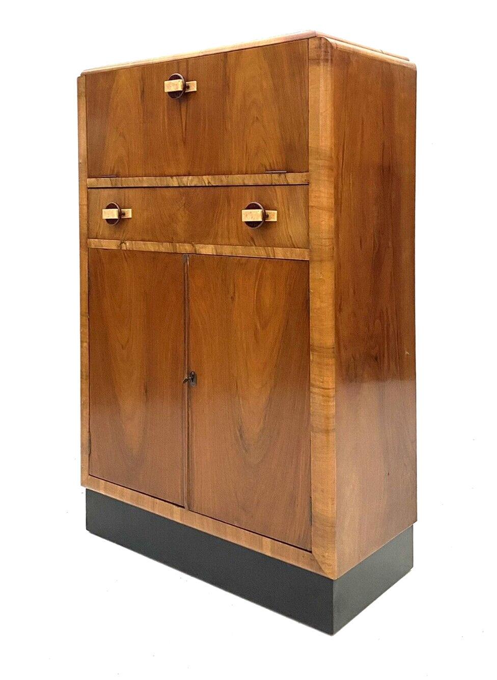For your consideration is this fabulously stylish 1930's Art Deco cocktail cabinet. This dry bar dates to the 1930's and has all the bells and whistles you want from a cocktail cabinet. The upper interior has a mirrored base and mirrored backing .