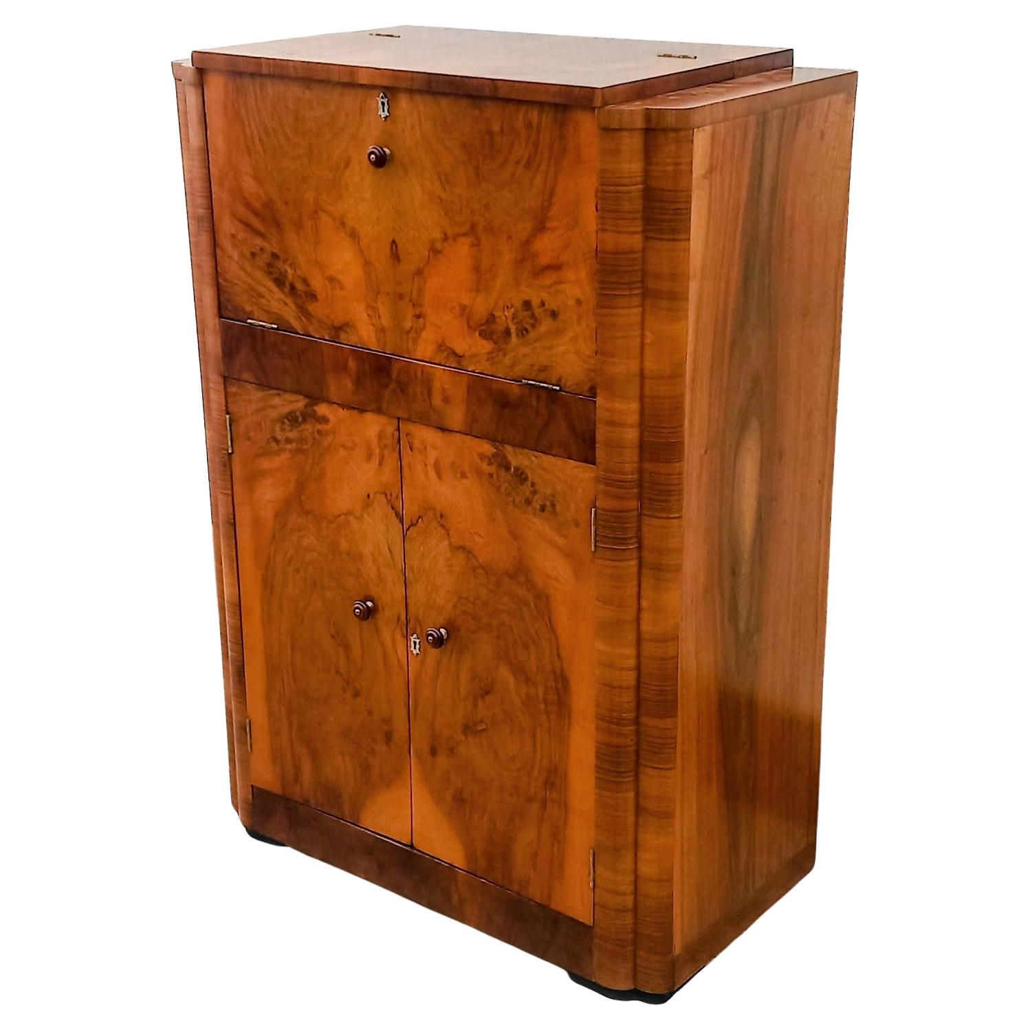 For your consideration is this fabulously stylish 1930's Art Deco cocktail cabinet. This dry bar dates to the 1930's and has all the bells and whistles you want from a cocktail cabinet. The upper interior has a mirrored base and mirrored backing .