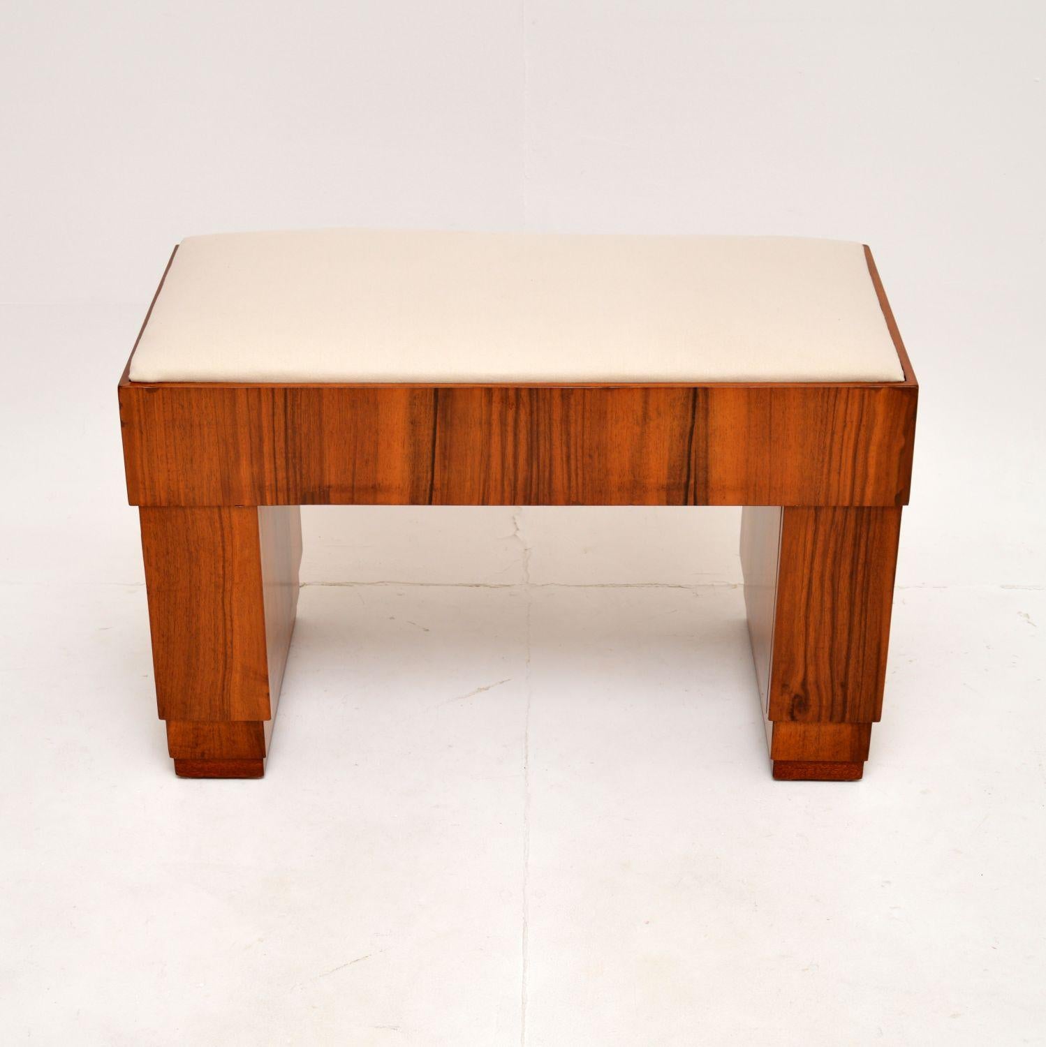 A beautiful and quite unusual Art Deco figured walnut duet piano stool. This was made in England, it dates from the 1920-30’s.

The quality is superb, this has a stylish and very functional design. The walnut frame has a twin pedestal base, each