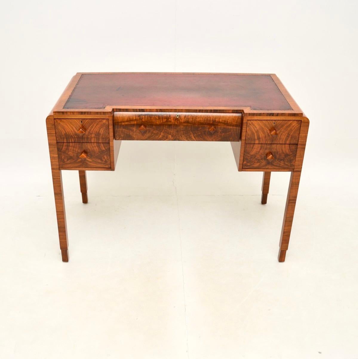 A smart and extremely well made Art Deco figured walnut leather top desk. This was made in England, it dates from the 1930’s.

The quality is outstanding and this is a lovely size. The top has an inverted breakfront design and has a wonderful inset