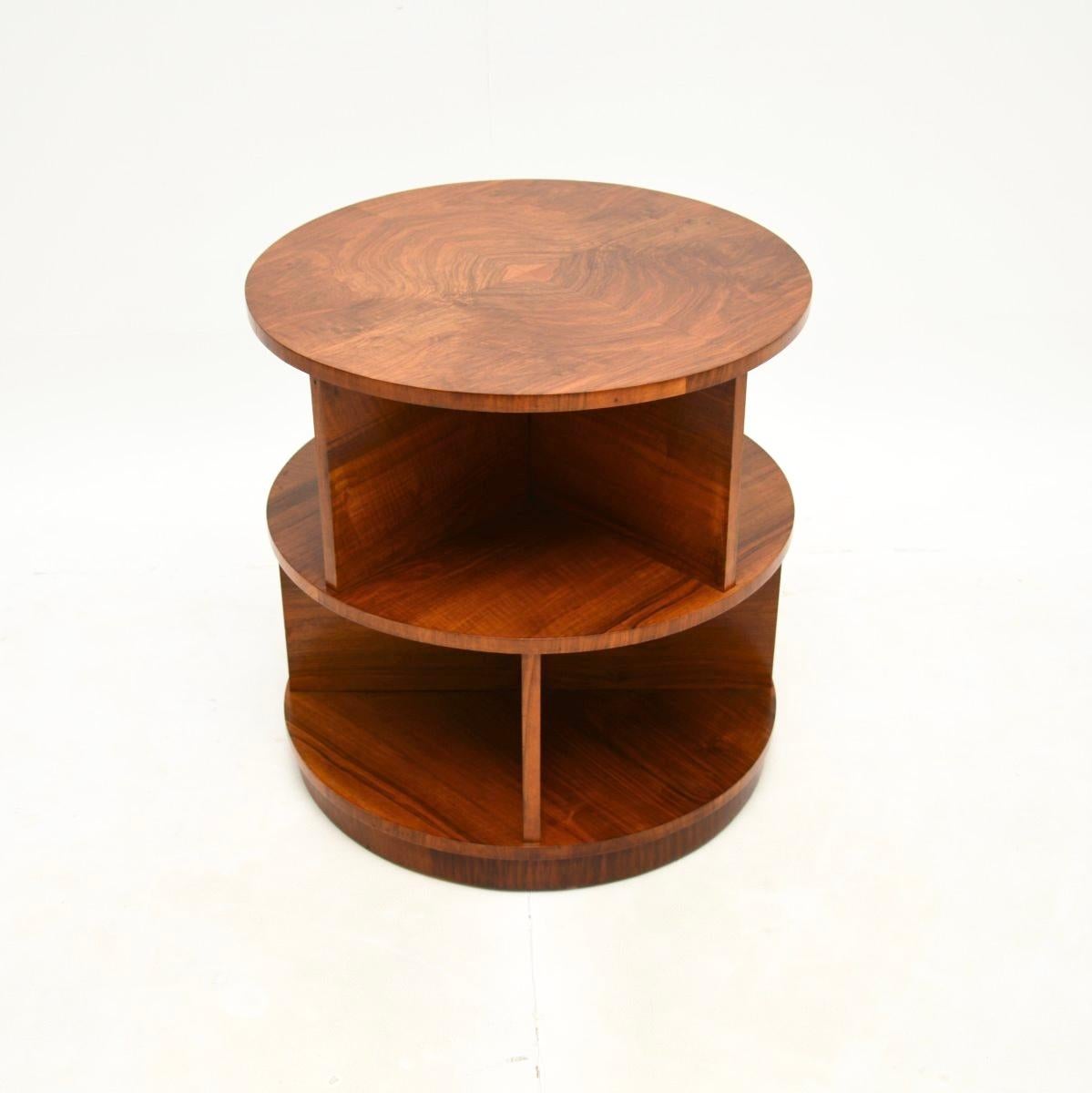 A fantastic original Art Deco figured walnut occasional side / centre table. This was made in England, it dates from the 1930’s.

It has a beautiful stepped design, the two circular tiers overhang each other with alternating dividing sections on