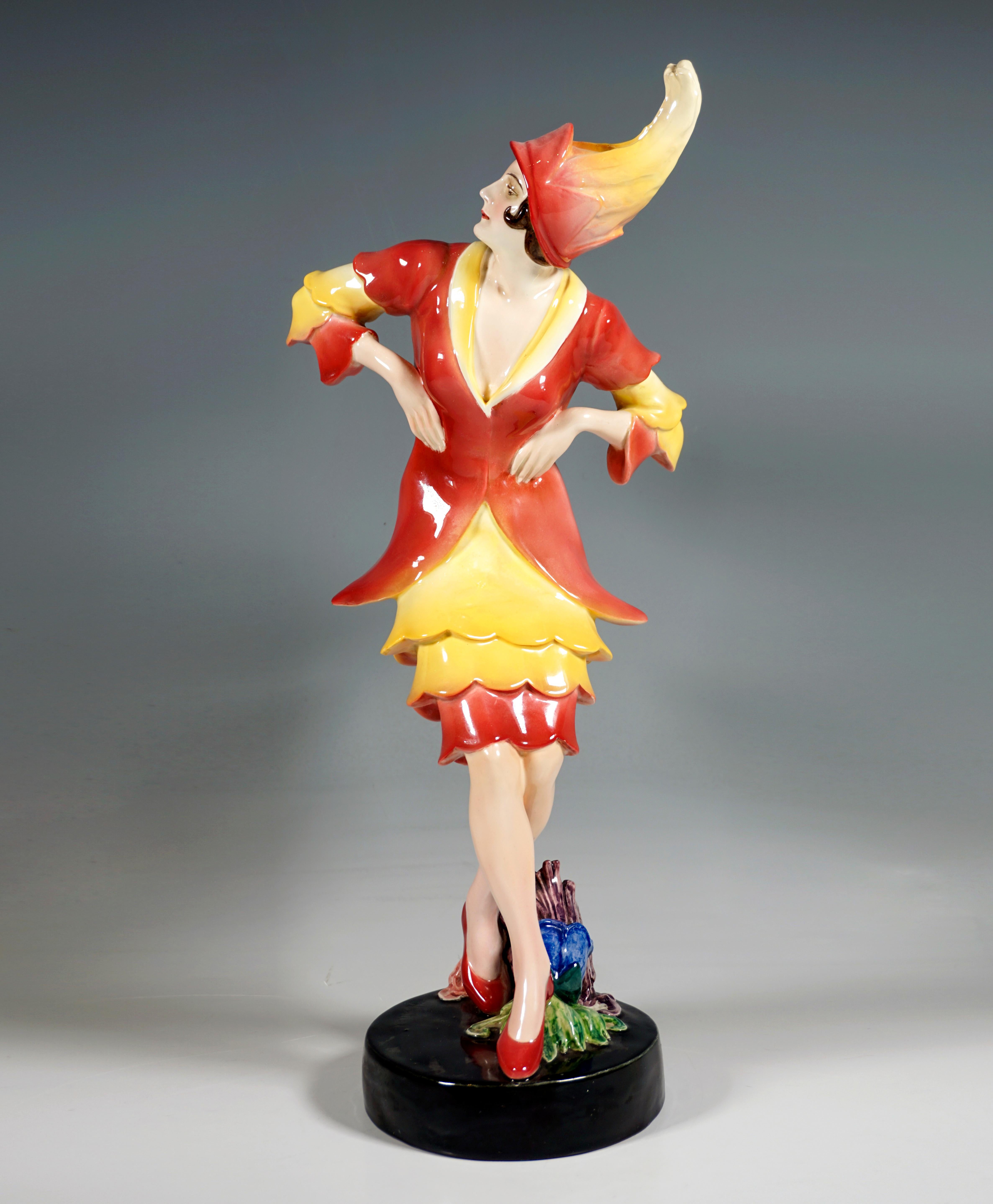 Rare Art Ceramics Model by Goldscheider from the 1920s:
Portrayal of the dancer Lucie Kieselhausen in an exotic costume consisting of a jacket and a short skirt, sleeves and skirt part with colored red to yellow graduated flounces with a wavy hem,