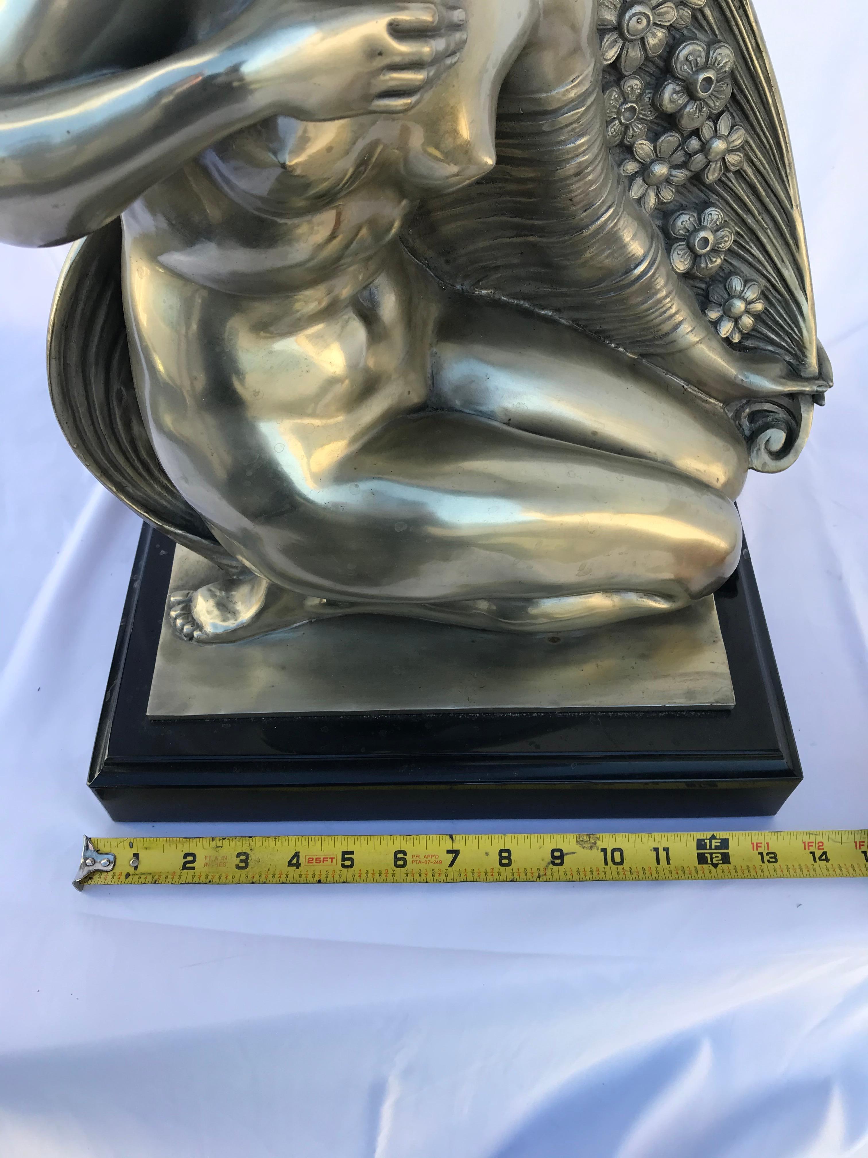Bella statuetta di ragazza nuda in ginocchio. Patina d'argento lucidata a specchio su bronzo fuso, fuso dopo l'originale da Joe Descomps, artista quotato. Una delle sue più grandi sculture. Presenta segni sulla base. Un blocco solido di marmo nero