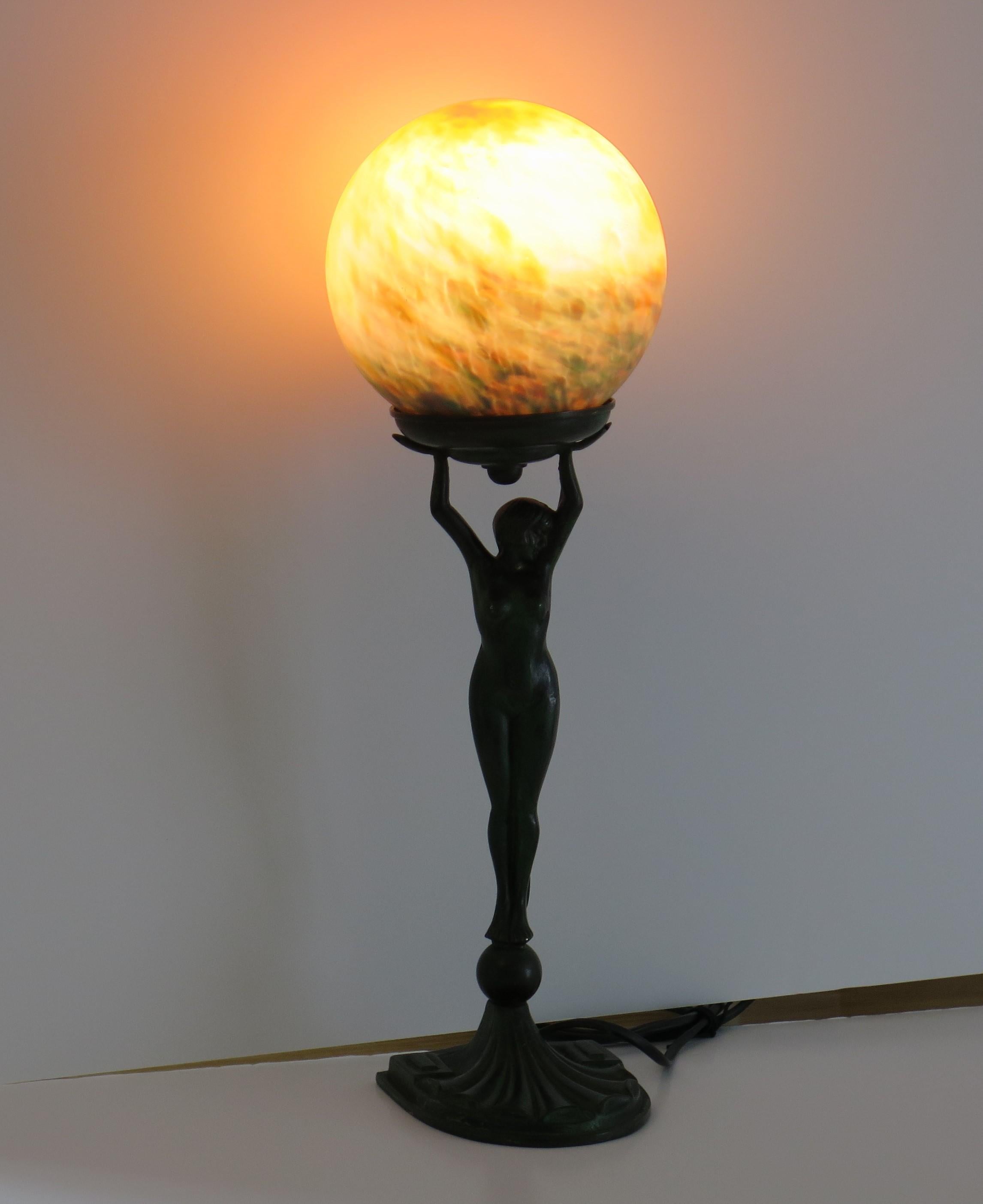 This is a stunning figurine table lamp of a nude lady bronze Figurine sculpture made in France, circa 1930.

The figurine is heavy and made of bronze metal with good detail. It has been cold painted with a green colour which has worn away in