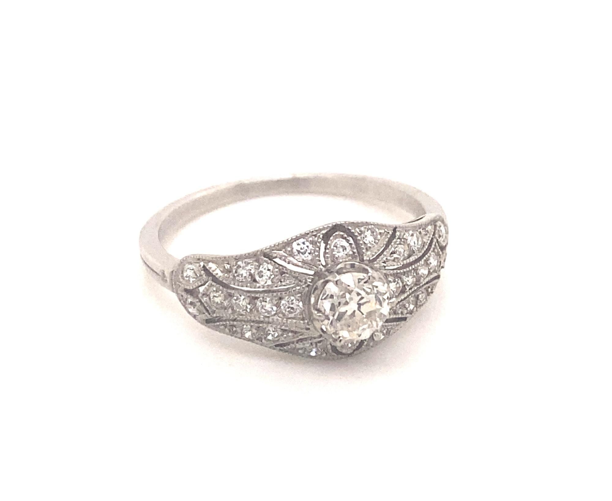 This is a beautiful art deco style ring with an intricate filigree design in platinum.  The ring is set with .38 carat old mine cut in the center I color VS-2 clarity.  There are 26 additional diamonds H color VS-2 clarity total weight .60 carats.