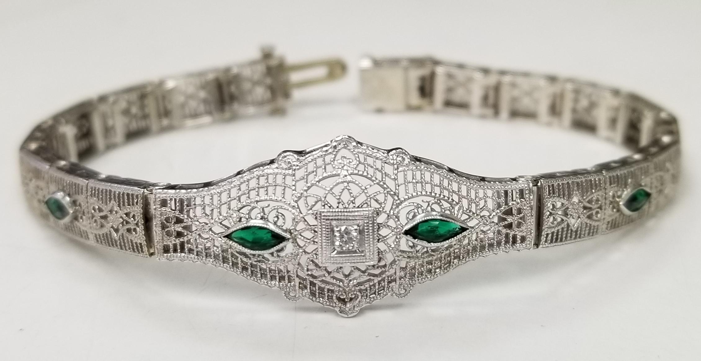 Beautiful women's Art Deco filigree bracelet in 14k white gold. This bracelet features round brilliant cut diamonds and  marquise emeralds.  The bracelet has a solid clasp and safety. 
Specifications:
    main stone: ROUND CUT 
    additional: