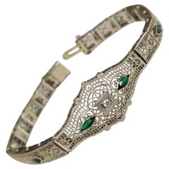 Art Deco Filigree "Belly" Bracelet in 14 Karat Gold with Diamonds and Emeralds