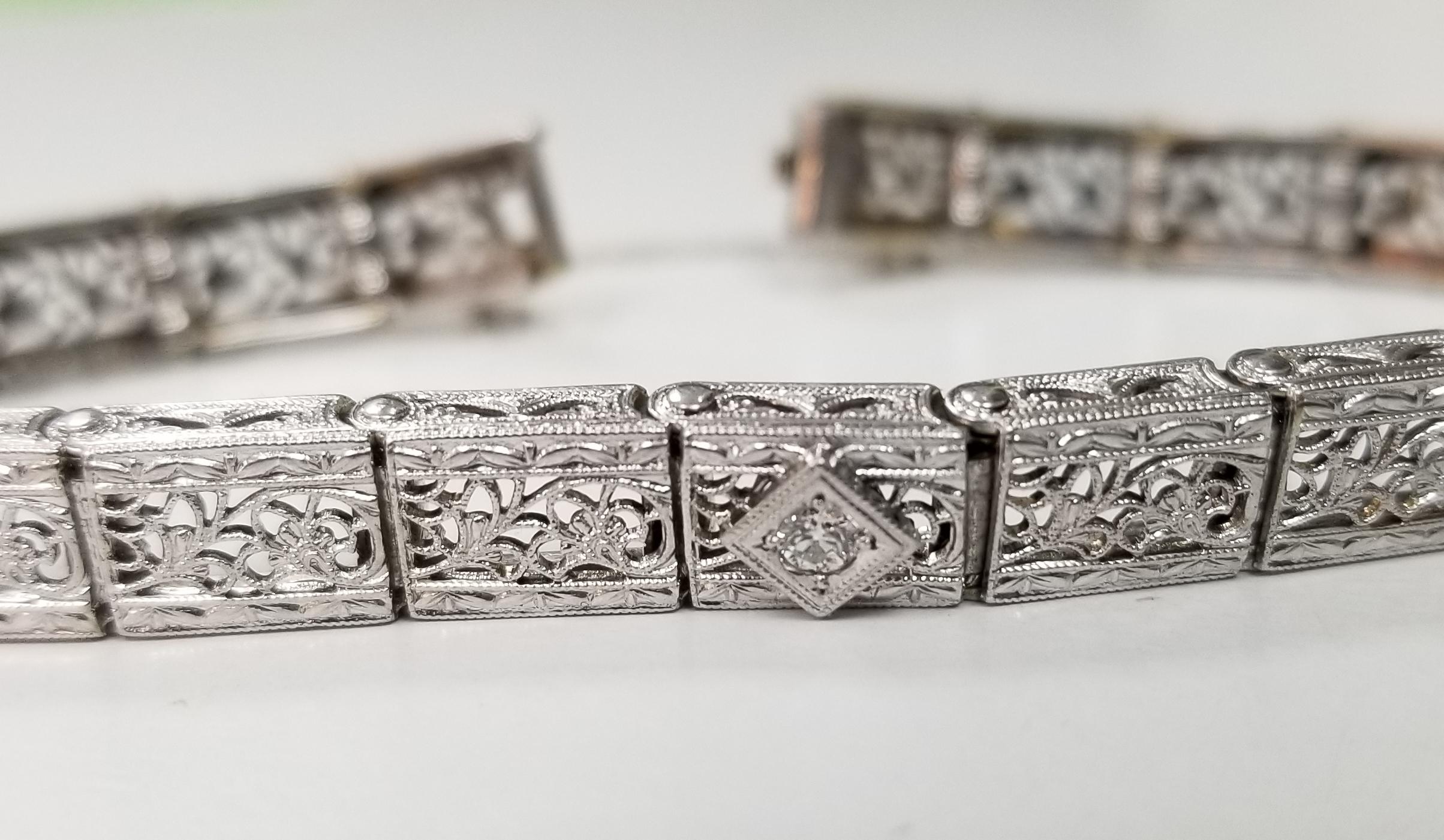 Beautiful women's Art Deco style filigree bracelet in 14k white gold. This bracelet features 1 round brilliant cut diamonds and 2 square cut sapphires.  The bracelet has a solid clasp and safety. 
Specifications:
    main stone: ROUND CUT 
   